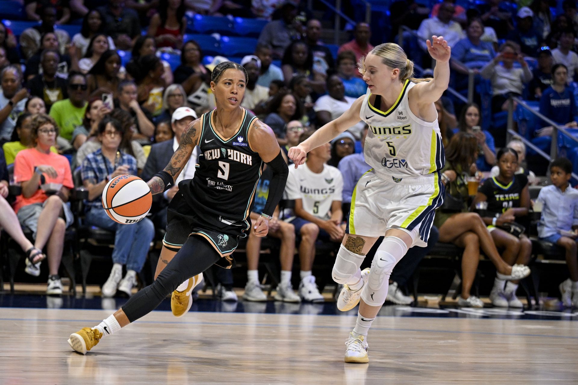 New York Liberty guard Natasha Cloud (9) and Dallas Wings guard Paige Bueckers (5) in action during the game between the Dallas Wings and the New York Liberty at College Park Center.