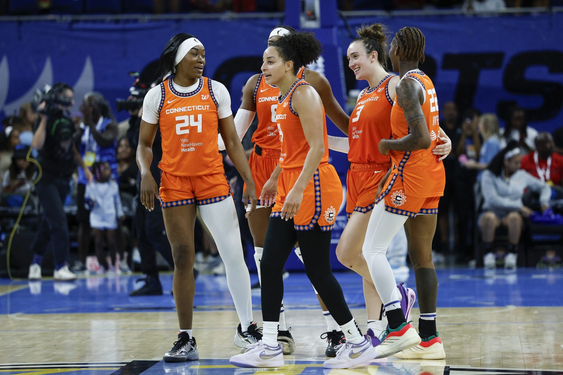 Connecticut Sun players celebrate teams win against the Chicago Sky in a WNBA game at Wintrust Arena - Source: Imagn Images