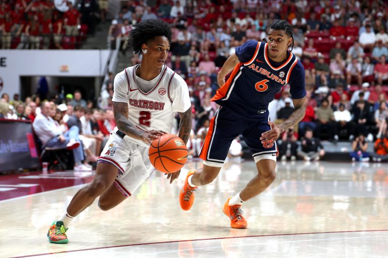 Alabama Crimson Tide guard Aden Holloway (2) dribbles against Auburn Tigers guard Elyjah Freeman (6) during the second half at Coleman Coliseum.