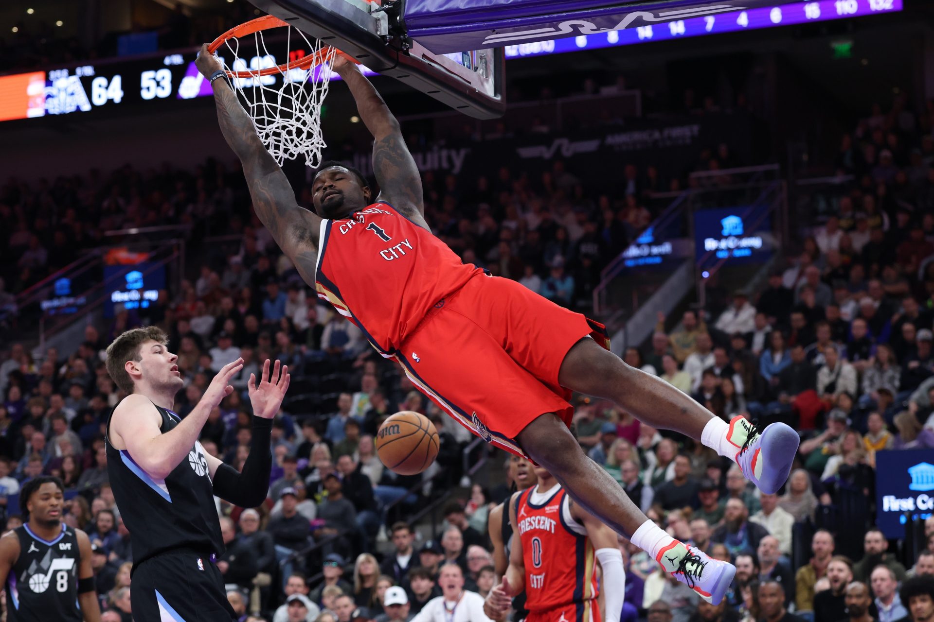 New Orleans Pelicans forward Zion Williamson (1) holds on to the rim after a dunk against the Utah Jazz during the first half at Delta Center - Source: Imagn Images