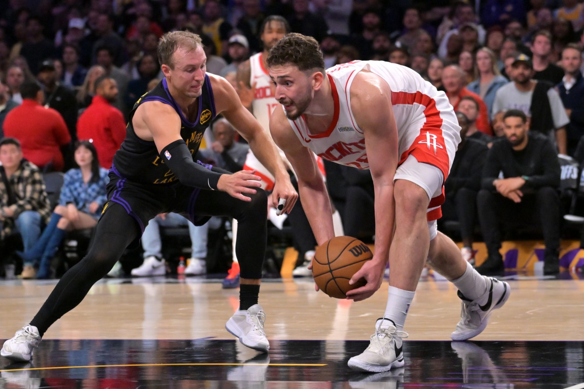 Los Angeles Lakers guard Luke Kennard (10) defends Houston Rockets center Alperen Sengun (28) after a reoubnd during the second half of game two of the first round of the 2026 NBA Playoffs at Crypto.com Arena - Source: Imagn Images