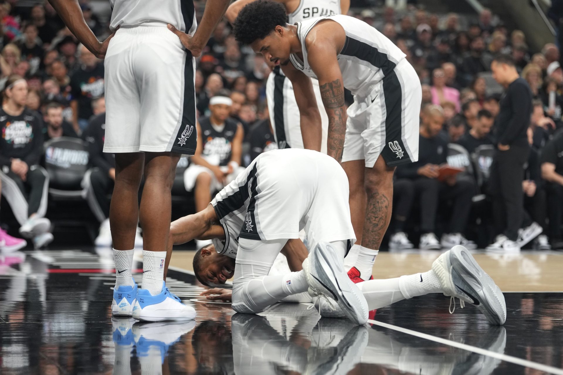 San Antonio Spurs forward Victor Wembanyama (1) reacts beside guard Dylan Harper (2) after falling to the ground during the first half of game two of the first round of the 2026 NBA Playoffs against the Portland Trail Blazers at Frost Bank Center. - Source: Imagn