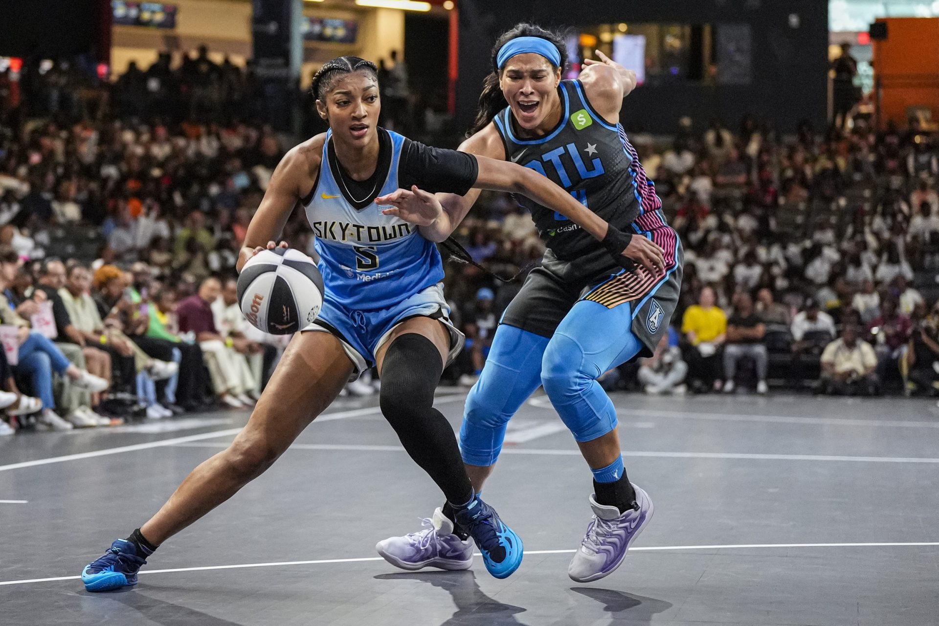 Chicago Sky forward Angel Reese (5) dribbles against Atlanta Dream forward Brionna Jones (24) during the first half at Gateway Center Arena at College Park. - Source: Imagn