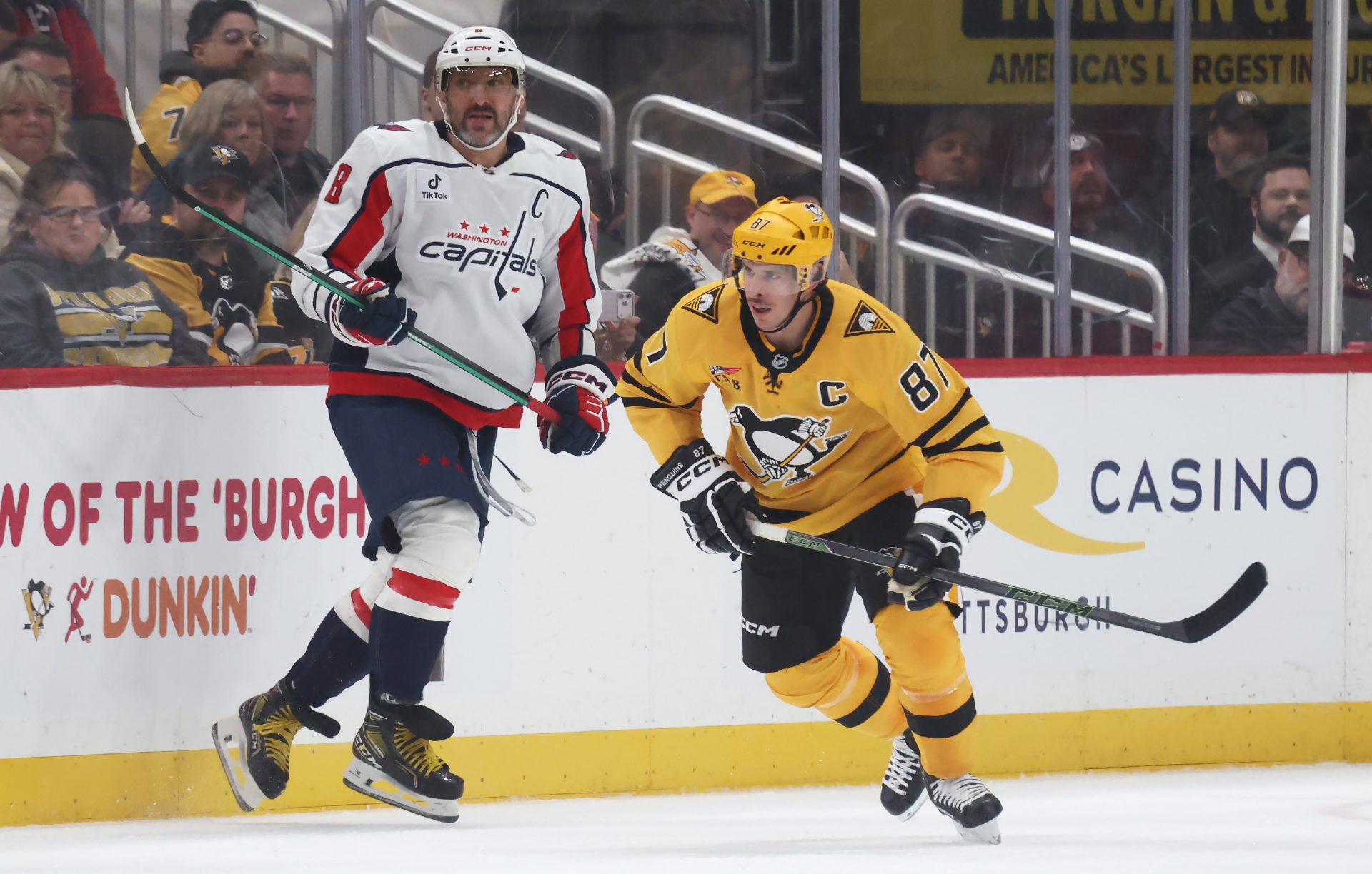 Washington Capitals left wing Alex Ovechkin (8) and Pittsburgh Penguins center Sidney Crosby (87) follow the puck during the third period at PPG Paints Arena.