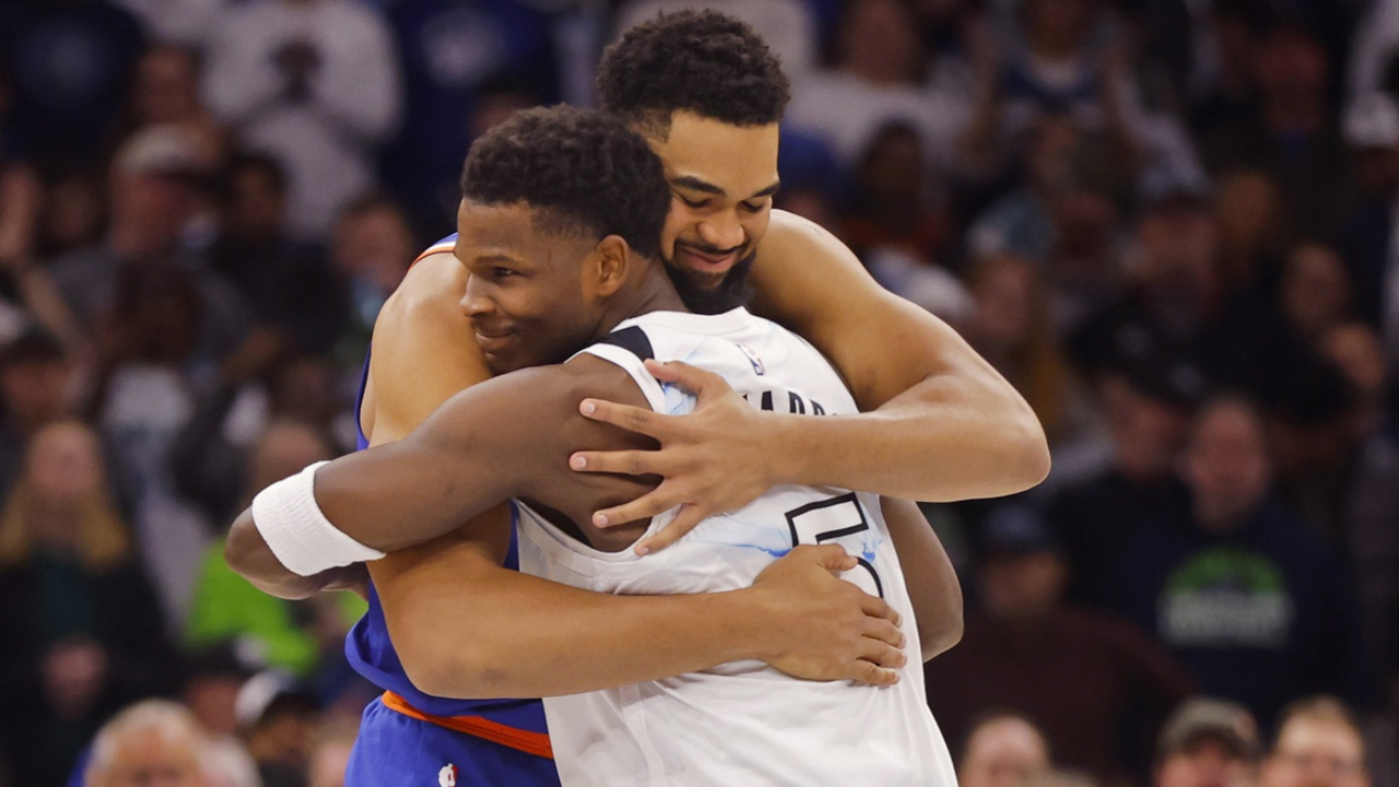 New York Knicks forward Karl-Anthony Towns (32) and Minnesota Timberwolves guard Anthony Edwards (5) hug before the game at Target Center.