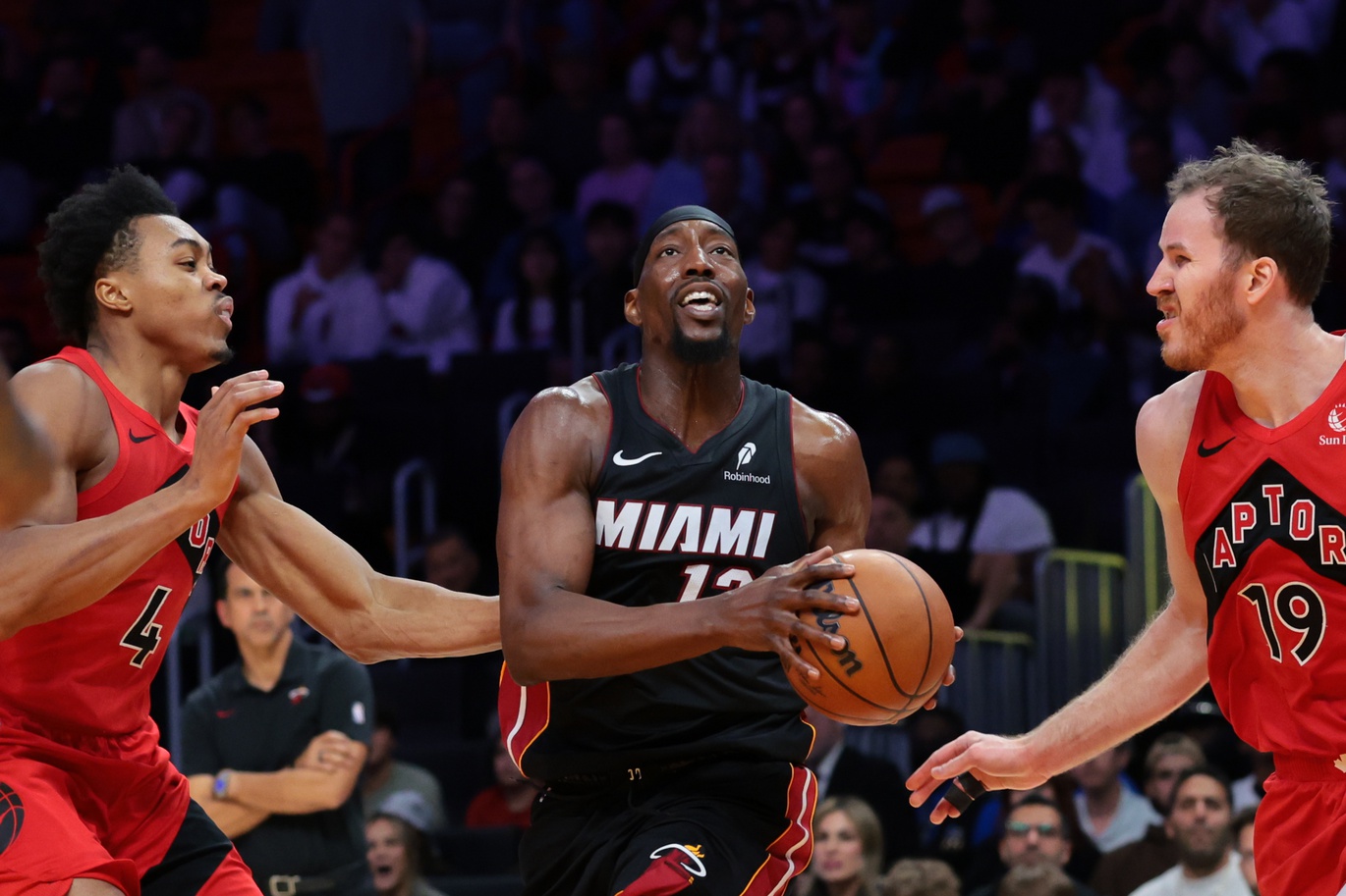 Miami Heat center Bam Adebayo (13) drives to the basket against Toronto Raptors forward Scottie Barnes (4) and center Jakob Poeltl (19) - Source: IMAGN