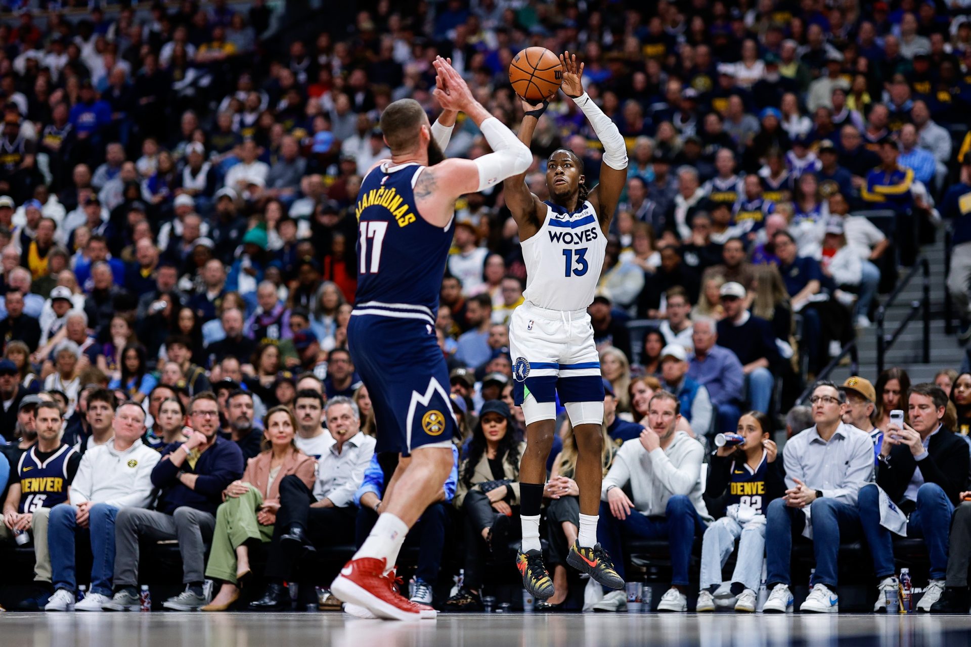 Minnesota Timberwolves guard Ayo Dosunmu (13) attempts a shot as Denver Nuggets center Jonas Valanciunas (17) defends in the second quarter during game five of the first round of the 2026 NBA Playoffs at Ball Arena - Source: Imagn Images