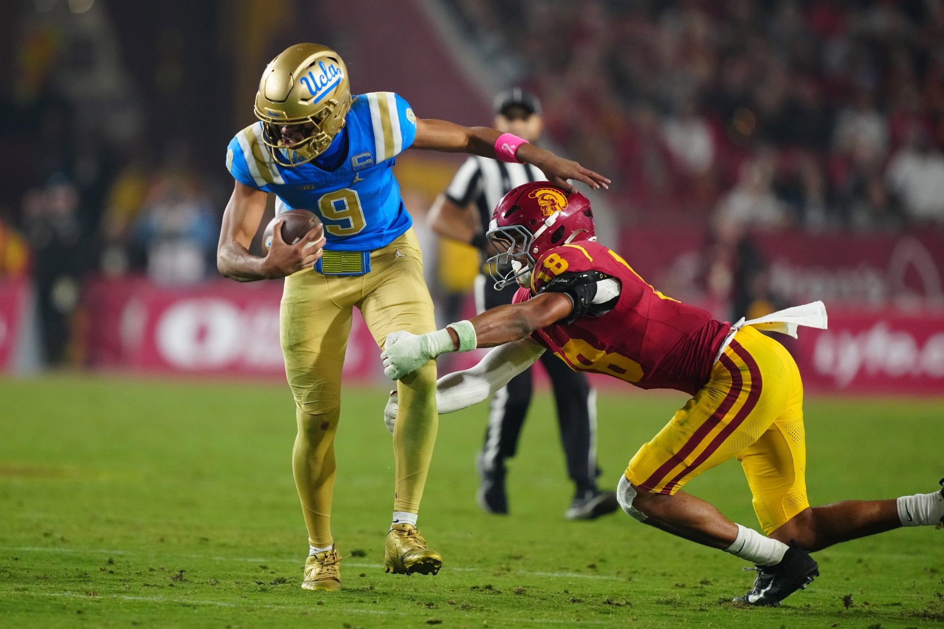 UCLA Bruins quarterback Nico Iamaleava (9) is tackled by Southern California Trojans linebacker Eric Gentry (18) in the second half at United Airlines Field at Los Angeles Memorial Coliseum. Source: Imagn