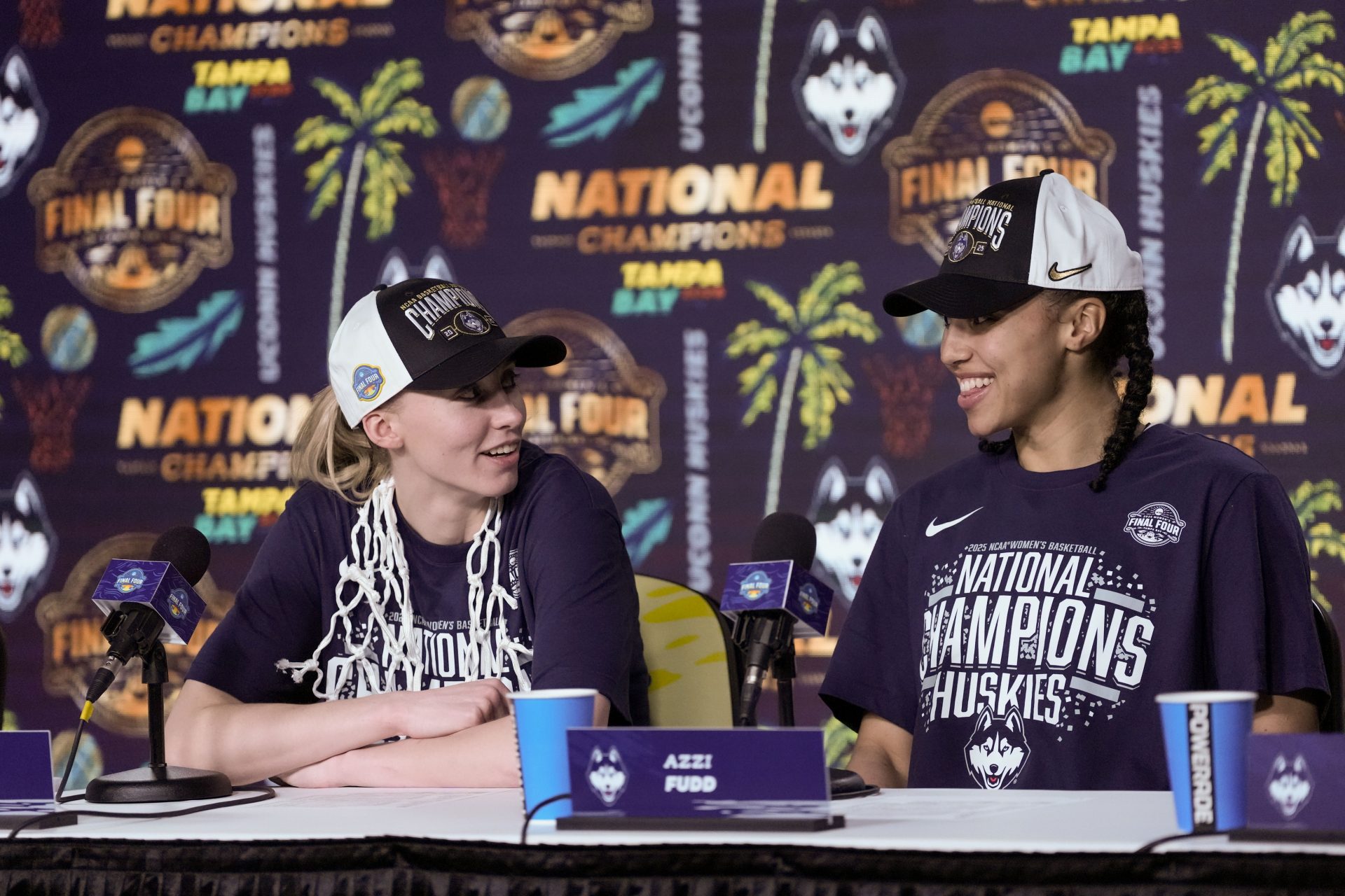 Connecticut Huskies guard Paige Bueckers (5) and guard Azzi Fudd (35) speak to the media after the national championship of the women's 2025 NCAA tournament against the South Carolina Gamecocks at Amalie Arena - Source: Imagn Images