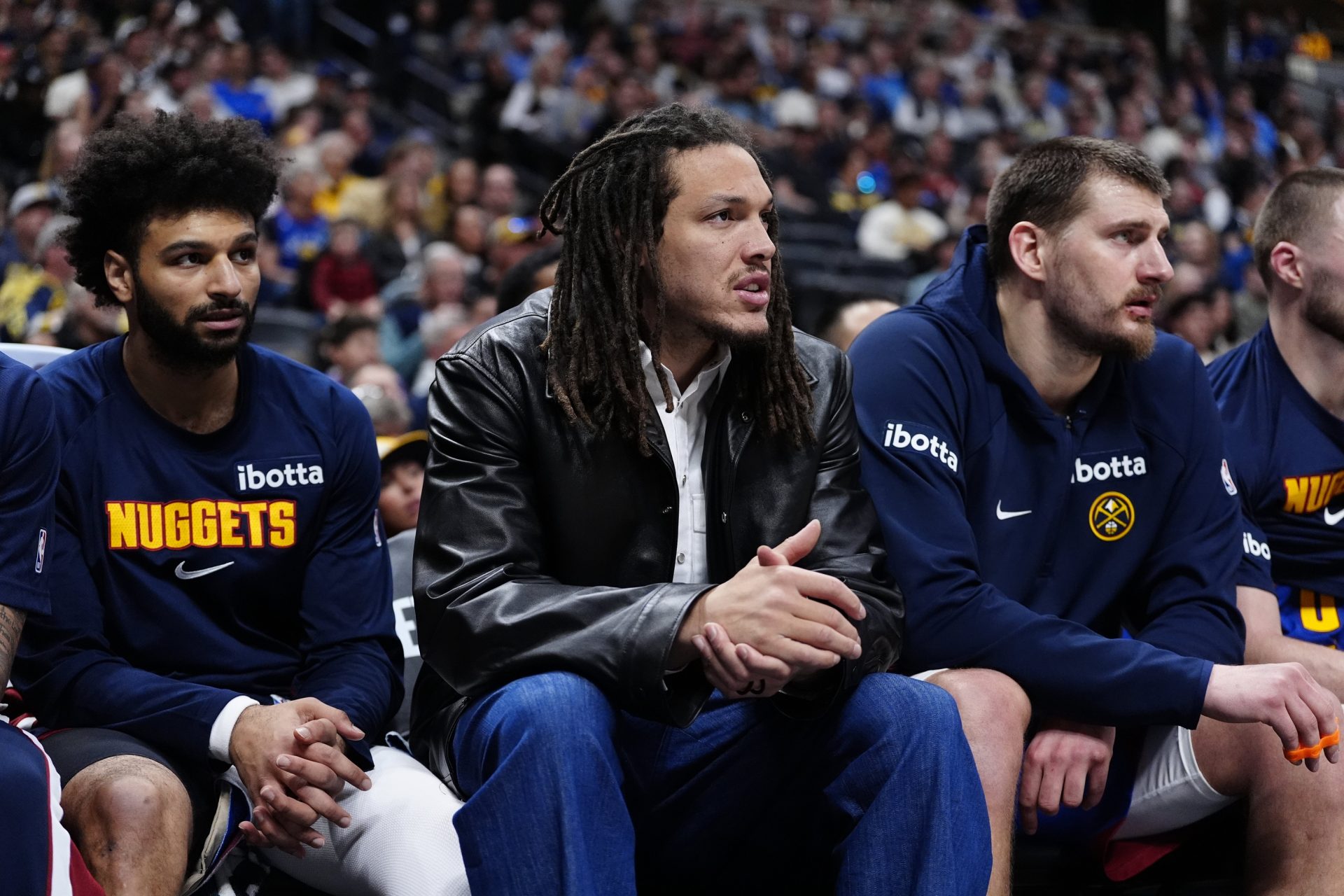 Denver Nuggets guard Jamal Murray (27) and forward Aaron Gordon (32) and center Nikola Jokic (15) on the bench during the second quarter against the Minnesota Timberwolves at Ball Arena.