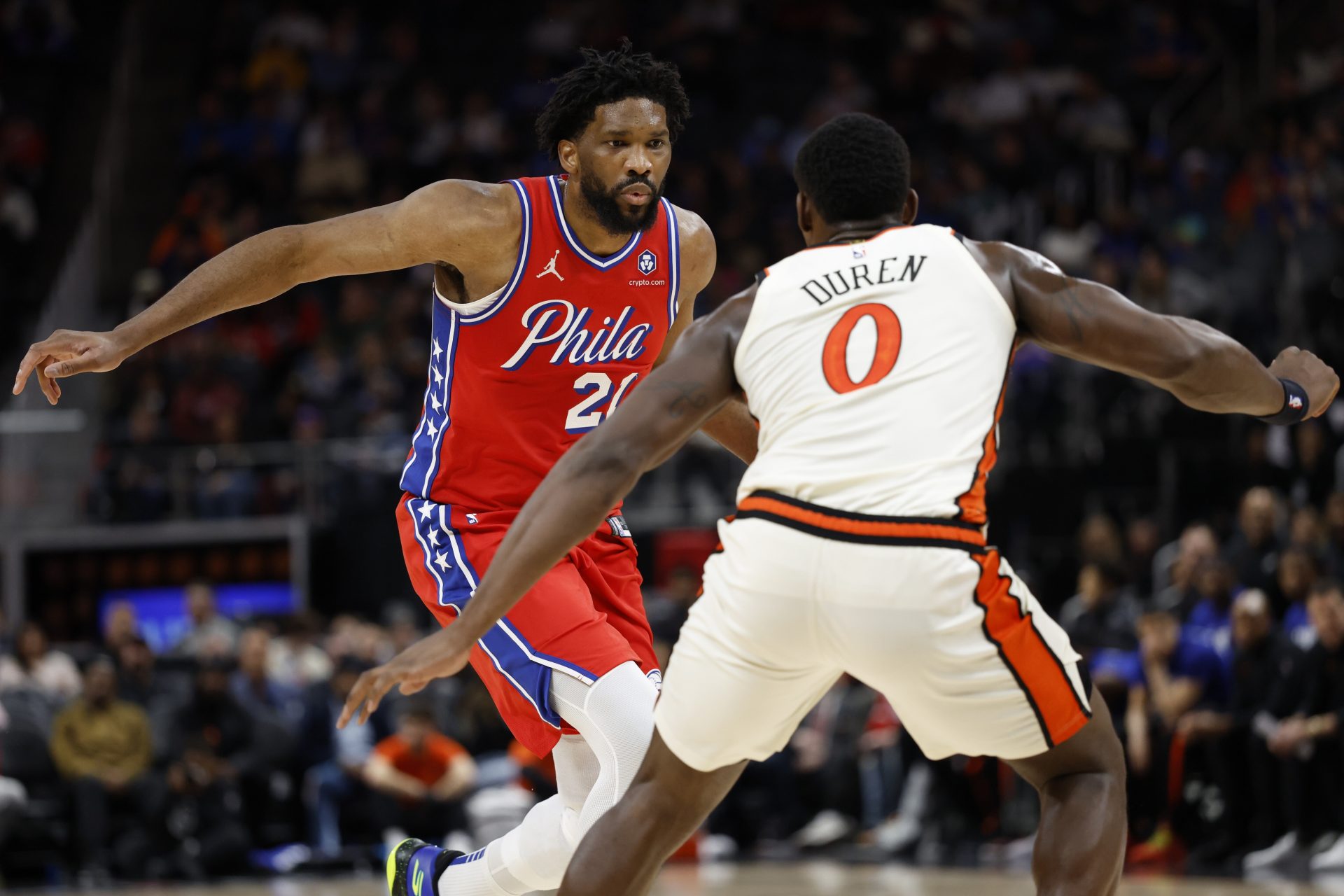 Philadelphia 76ers center Joel Embiid (21) dribbles defended by Detroit Pistons center Jalen Duren (0) in the first half at Little Caesars Arena.
