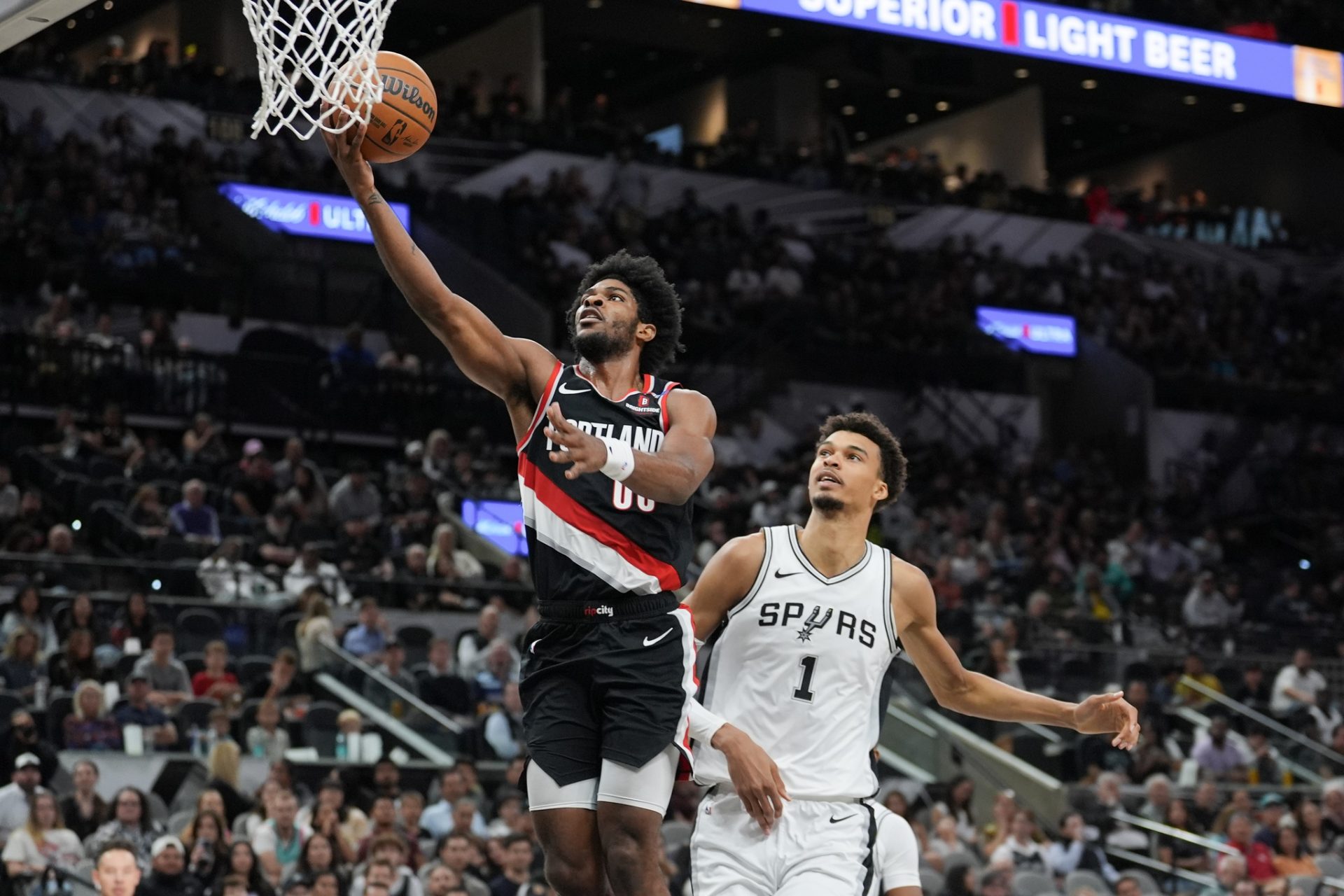 Portland Trail Blazers guard Scoot Henderson (00) shoots in front of San Antonio Spurs center Victor Wembanyama (1) in the second half at Frost Bank Center. - Source: Imagn