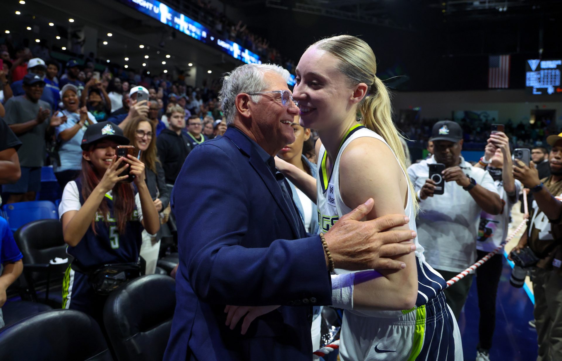 University of Connecticut head coach Geno Auriemma hugs Dallas Wings guard Paige Bueckers (5) after the game against the Golden State Valkyries at College Park Center. - Source: Imagn