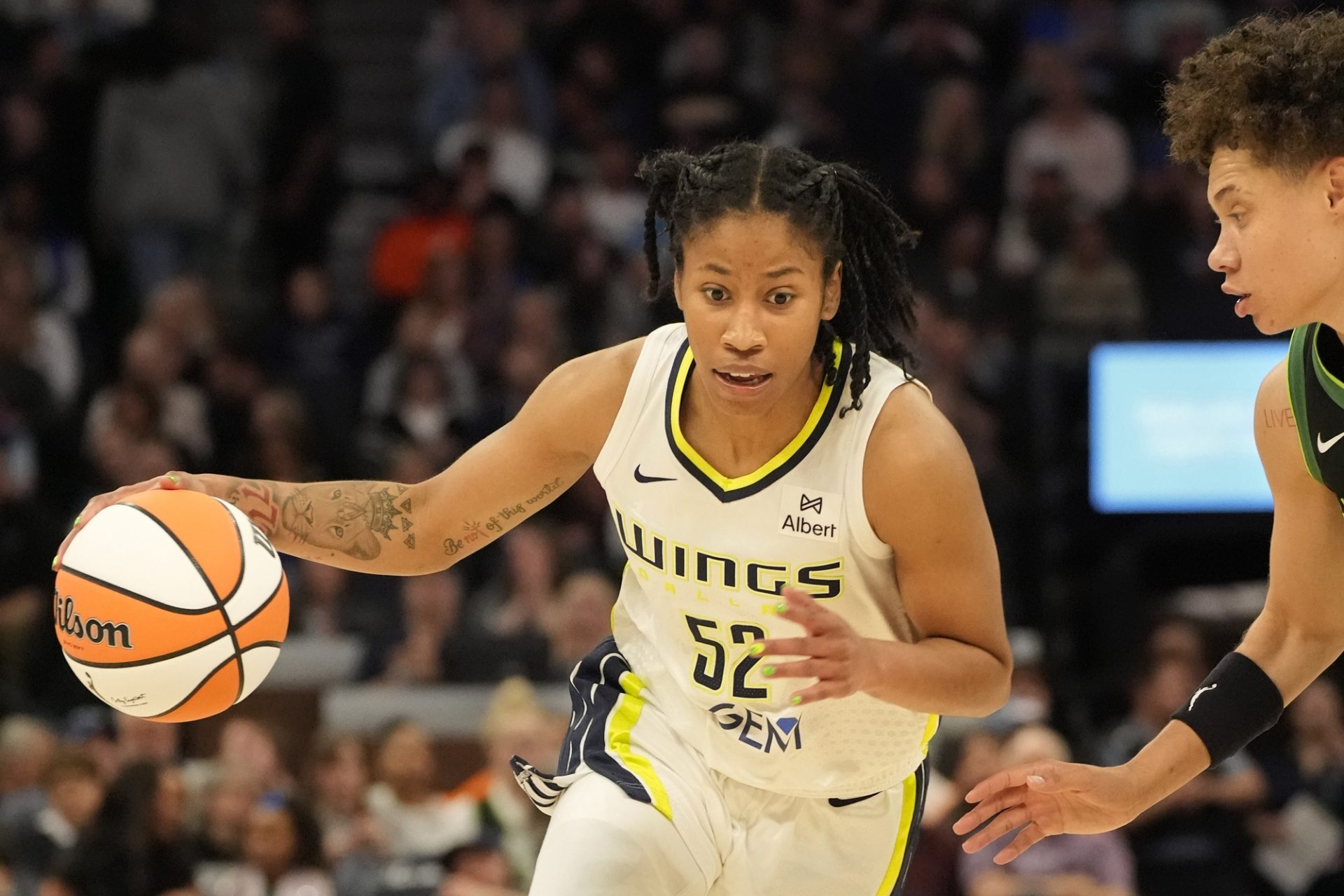 Dallas Wings guard Tyasha Harris (52) drives to the basket against Minnesota Lynx guard Natisha Hiedeman (2) in the second quarter at Target Center - Source: Imagn Images