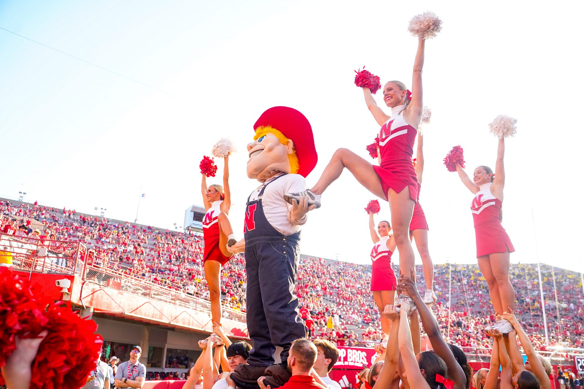 Herbie Husker is lifted with cheerleaders during the fourth quarter of the game the Nebraska Cornhuskers and the Michigan Wolverines at Memorial Stadium.