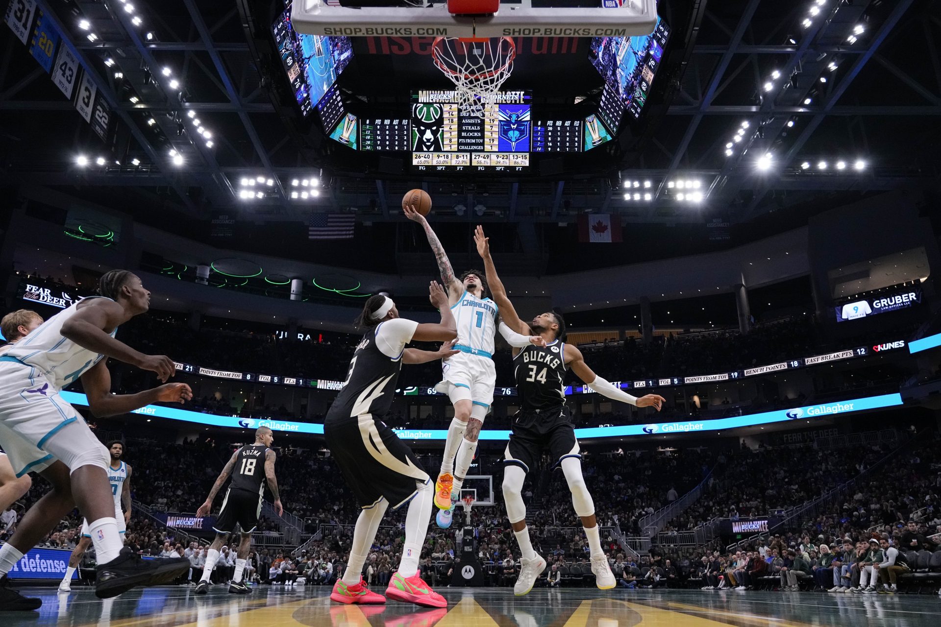 Charlotte Hornets guard LaMelo Ball (1) shoots between Milwaukee Bucks center Myles Turner (3) and Milwaukee Bucks forward Giannis Antetokounmpo (34) during the third quarter at Fiserv Forum. - Source: Imagn
