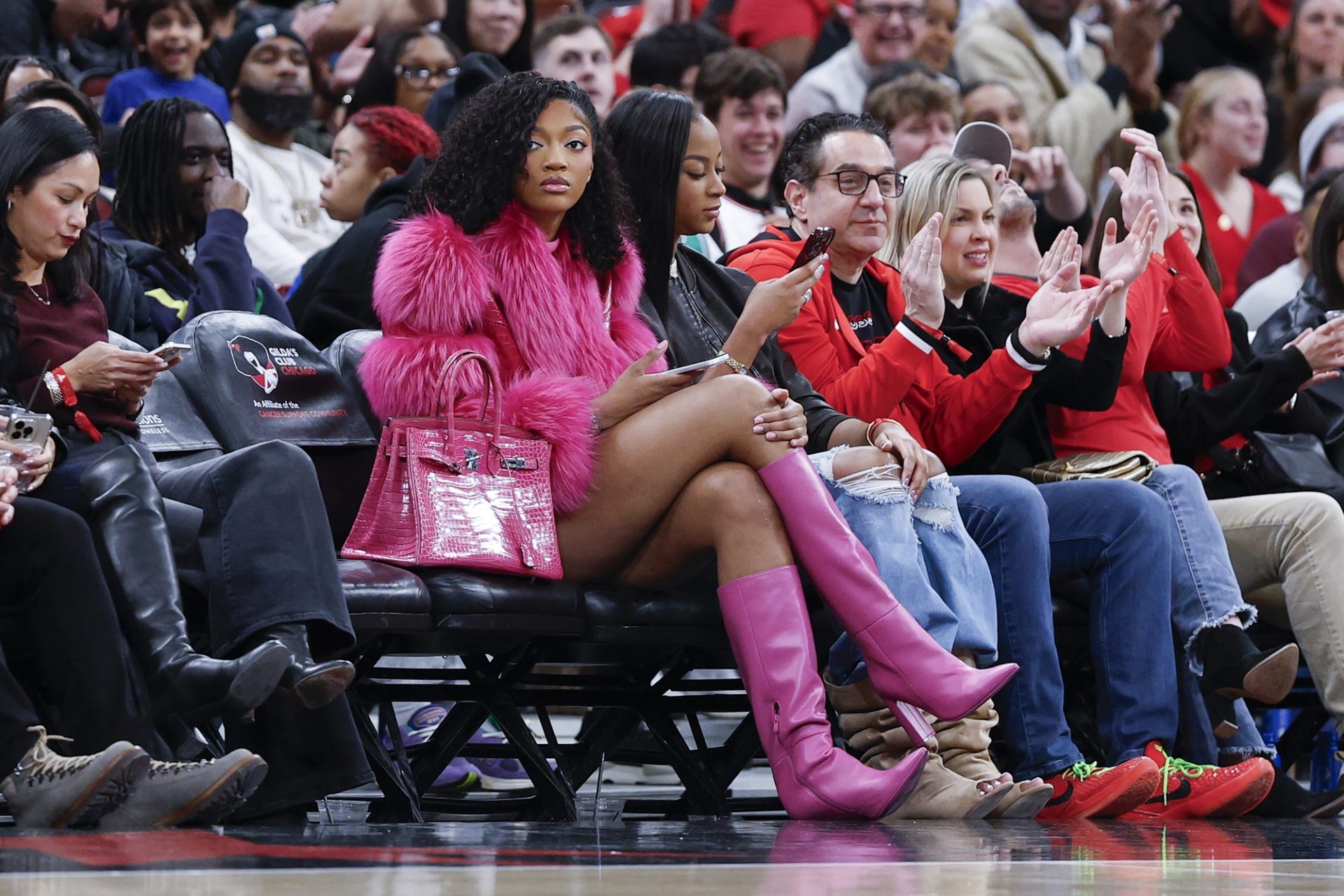 Chicago Sky forward Angel Reese watches a NBA game between the Chicago Bulls and Orlando Magic during the first half at United Center - Source: Imagn Images