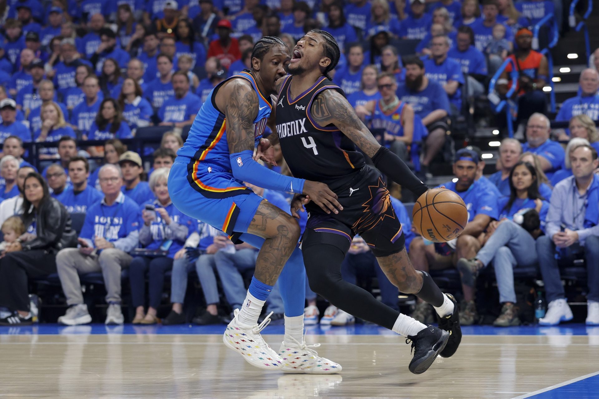 Phoenix Suns guard Jalen Green (4) is defended by Oklahoma City Thunder guard Jalen Williams (8) on a drive in the first quarter during game one of the first round of the 2026 NBA Playoffs at Paycom Center. - Source: Imagn