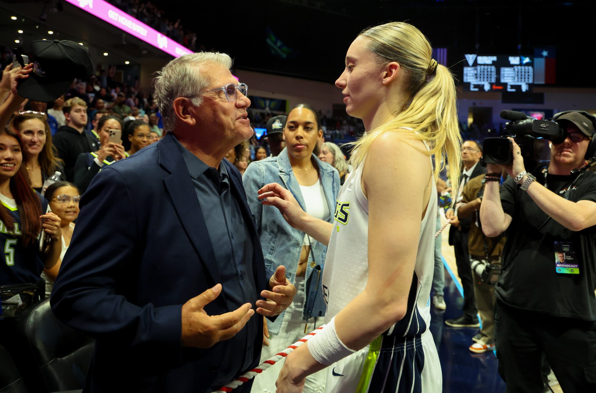 University of Connecticut head coach Geno Auriemma speaks with Dallas Wings guard Paige Bueckers (5) after the game against the Golden State Valkyries at College Park Center.