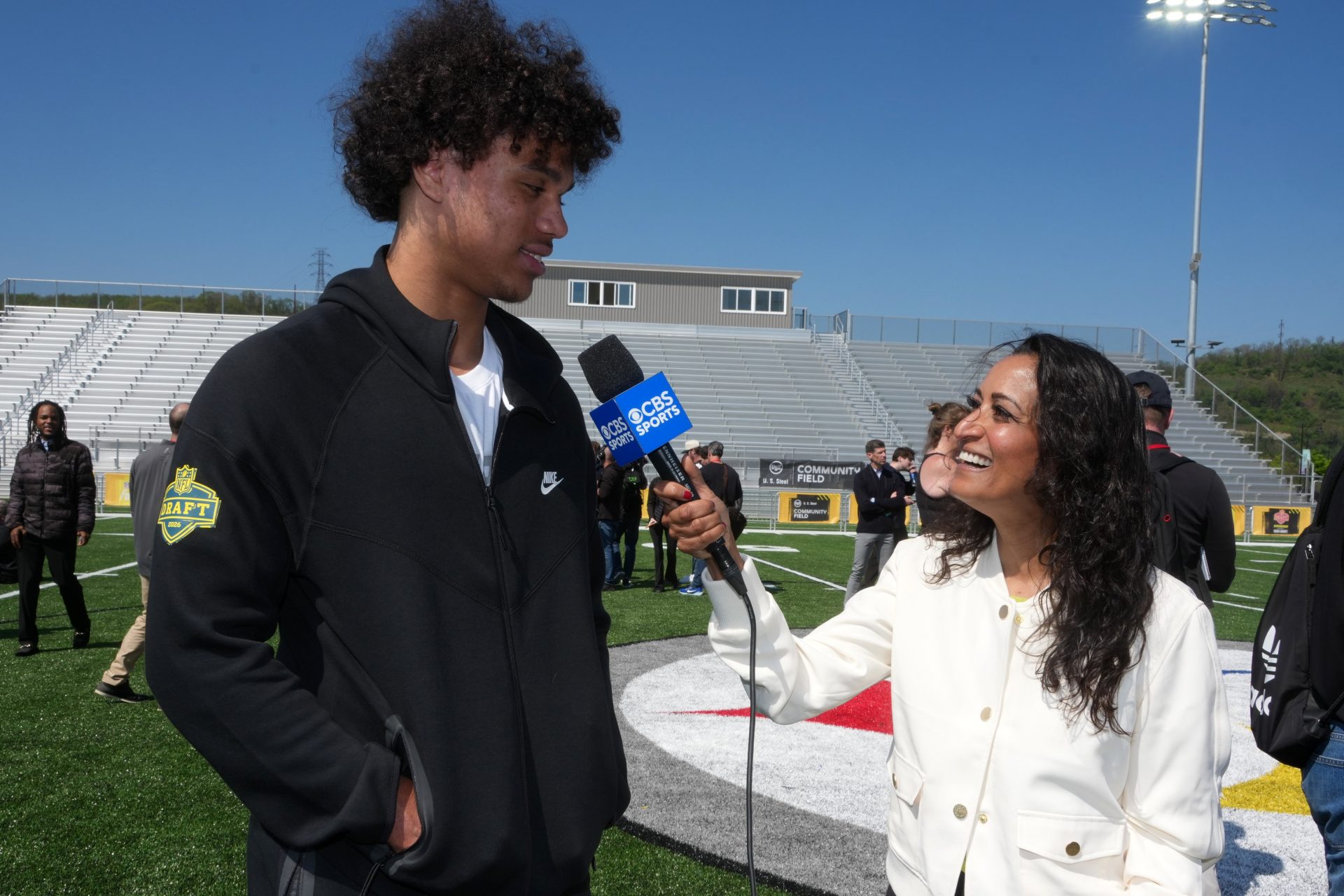 Arizona State Sun Devils receiver Jordyn Tyson (left) is interviewed by CBS Sports female reporter Aditi Kinkhabwala during the NFL Draft prospects clinic at Hazelwood Green Park.