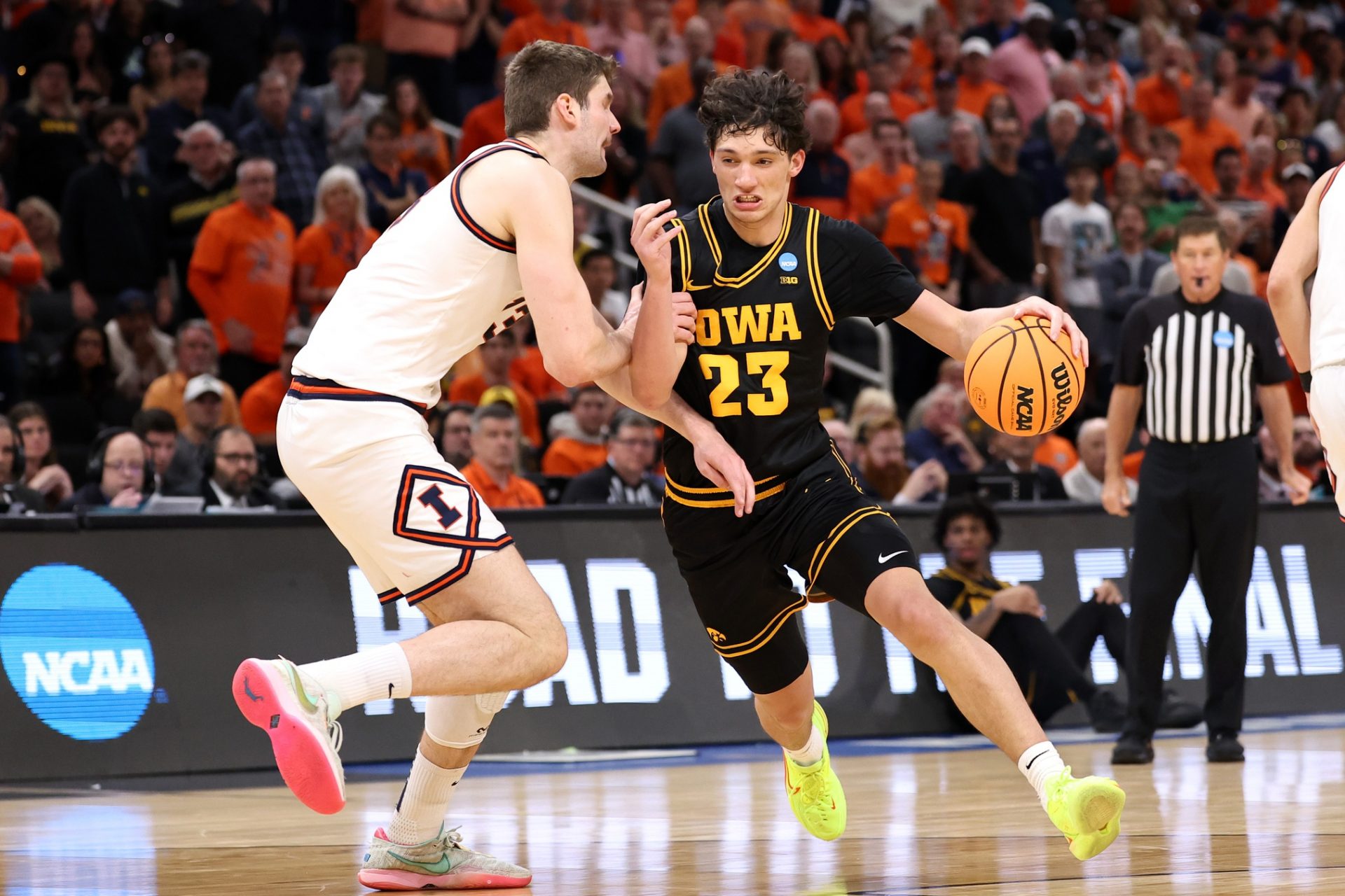Iowa Hawkeyes guard Isaia Howard (23) controls the ball against Illinois Fighting Illini center Tomislav Ivisic (13) in the second half during an Elite Eight game of the South Regional of the men's 2026 NCAA Tournament at Toyota Center - Source: Imagn