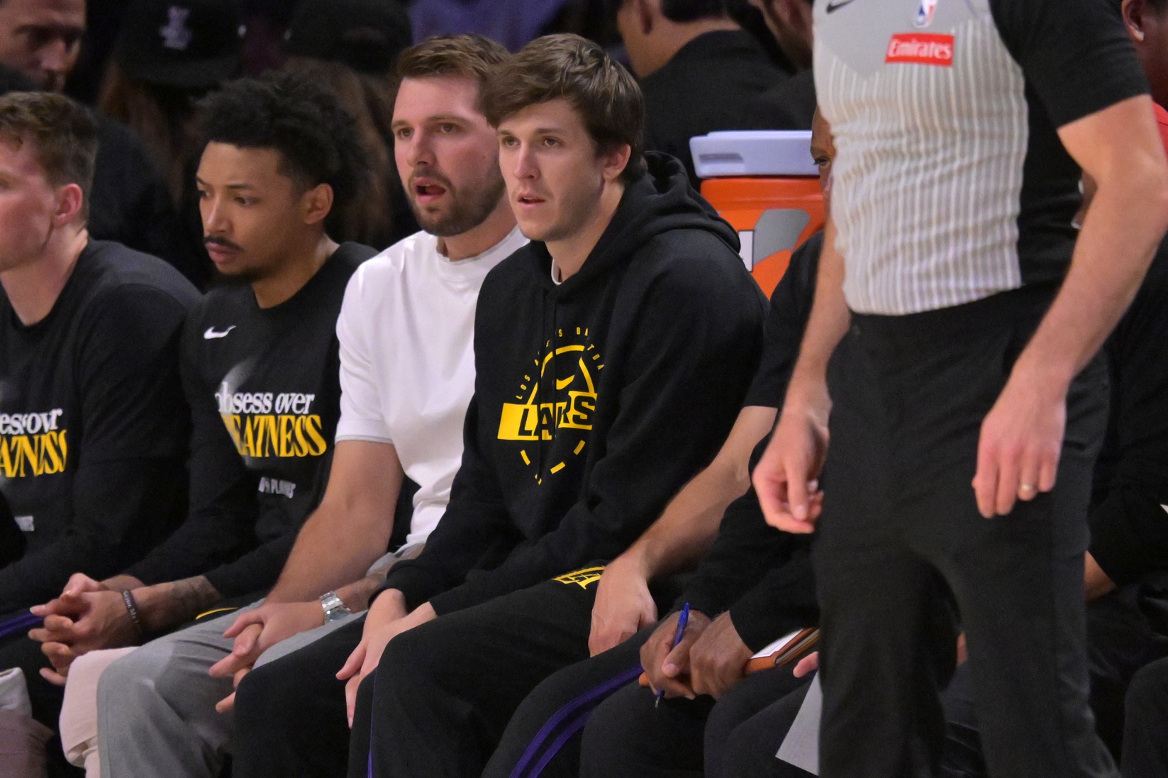 Los Angeles Lakers guard Luka Doncic (77) and guard Austin Reaves (15) look on from the bench in the first half of game two of the first round of the 2026 NBA Playoffs against the Houston Rockets at Crypto.com Arena.