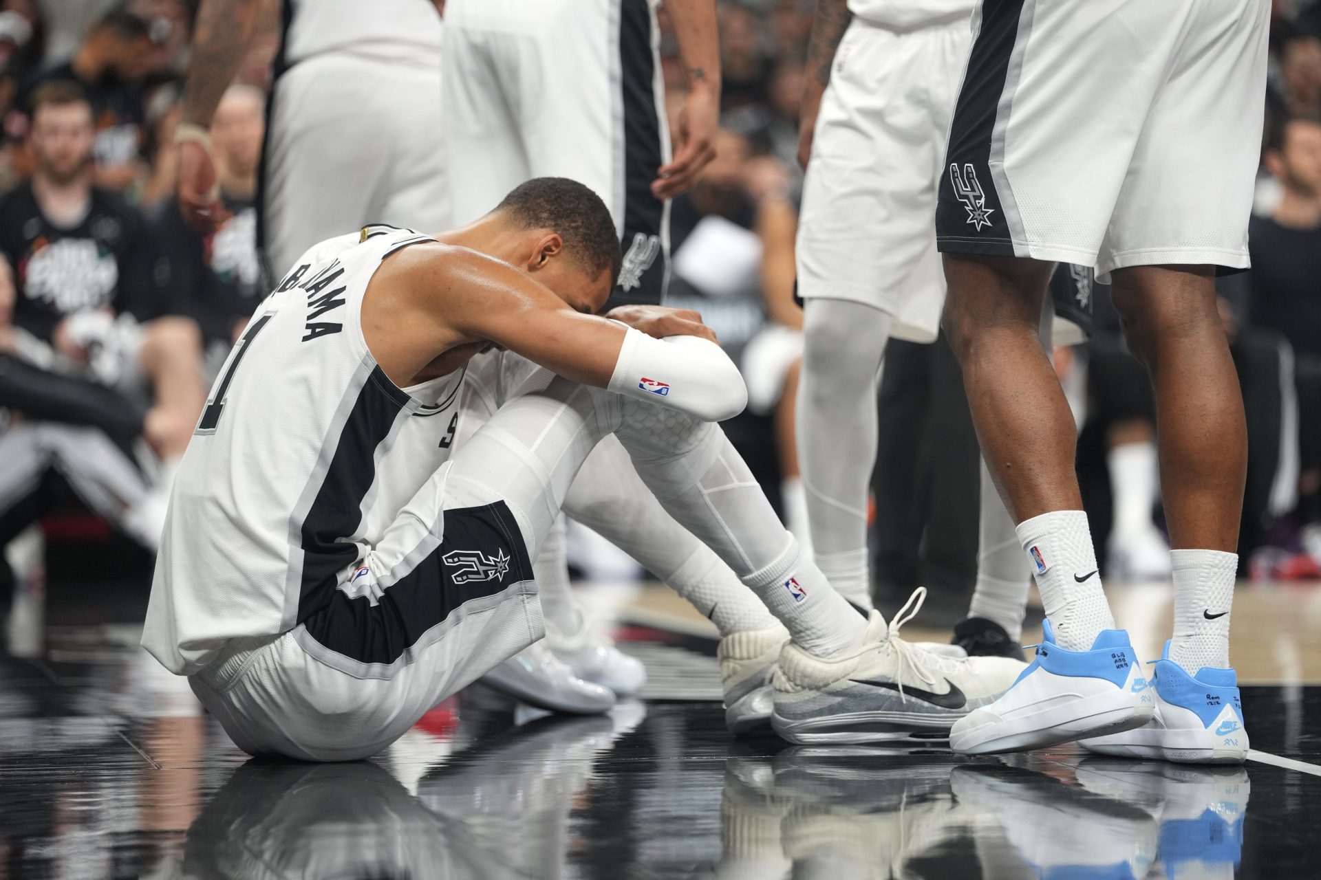 San Antonio Spurs forward Victor Wembanyama (1) reacts after falling to the ground during the first half of game two of the first round of the 2026 NBA Playoffs against the Portland Trail Blazers at Frost Bank Center.