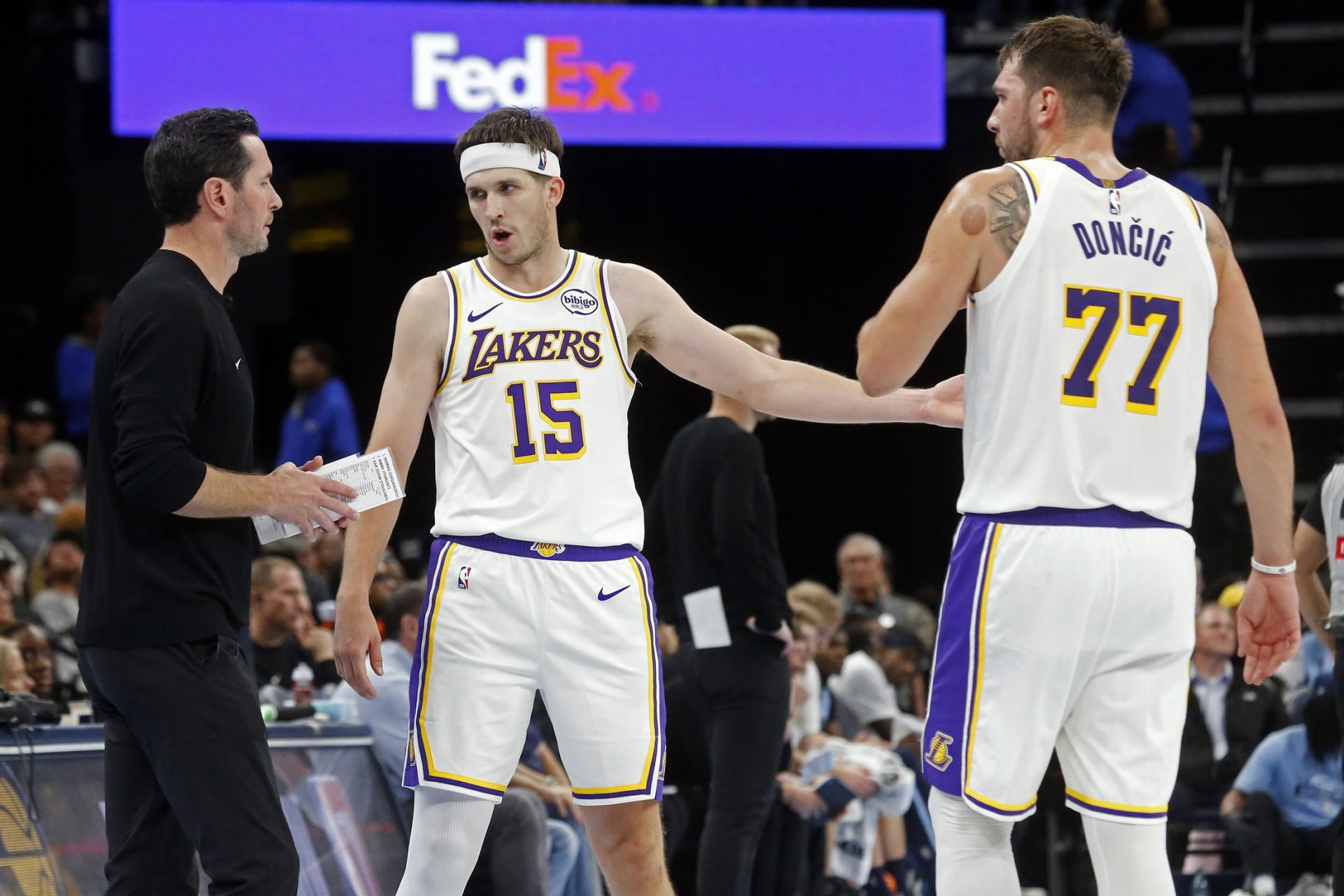 Los Angeles Lakers head coach JJ Redick talks with guard Austin Reaves (15) and guard Luka Doncic (77) during the fourth quarter against the Memphis Grizzlies at FedExForum. - Source: Imagn