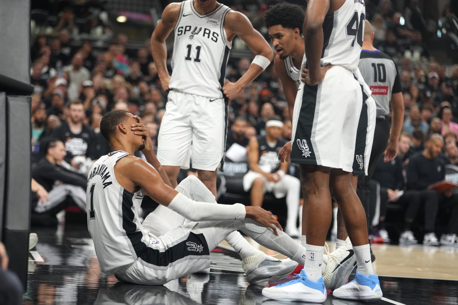 San Antonio Spurs forward Victor Wembanyama (1) reacts beside guard Dylan Harper (2) after falling to the ground during the first half of game two of the first round of the 2026 NBA Playoffs against the Portland Trail Blazers at Frost Bank Center.