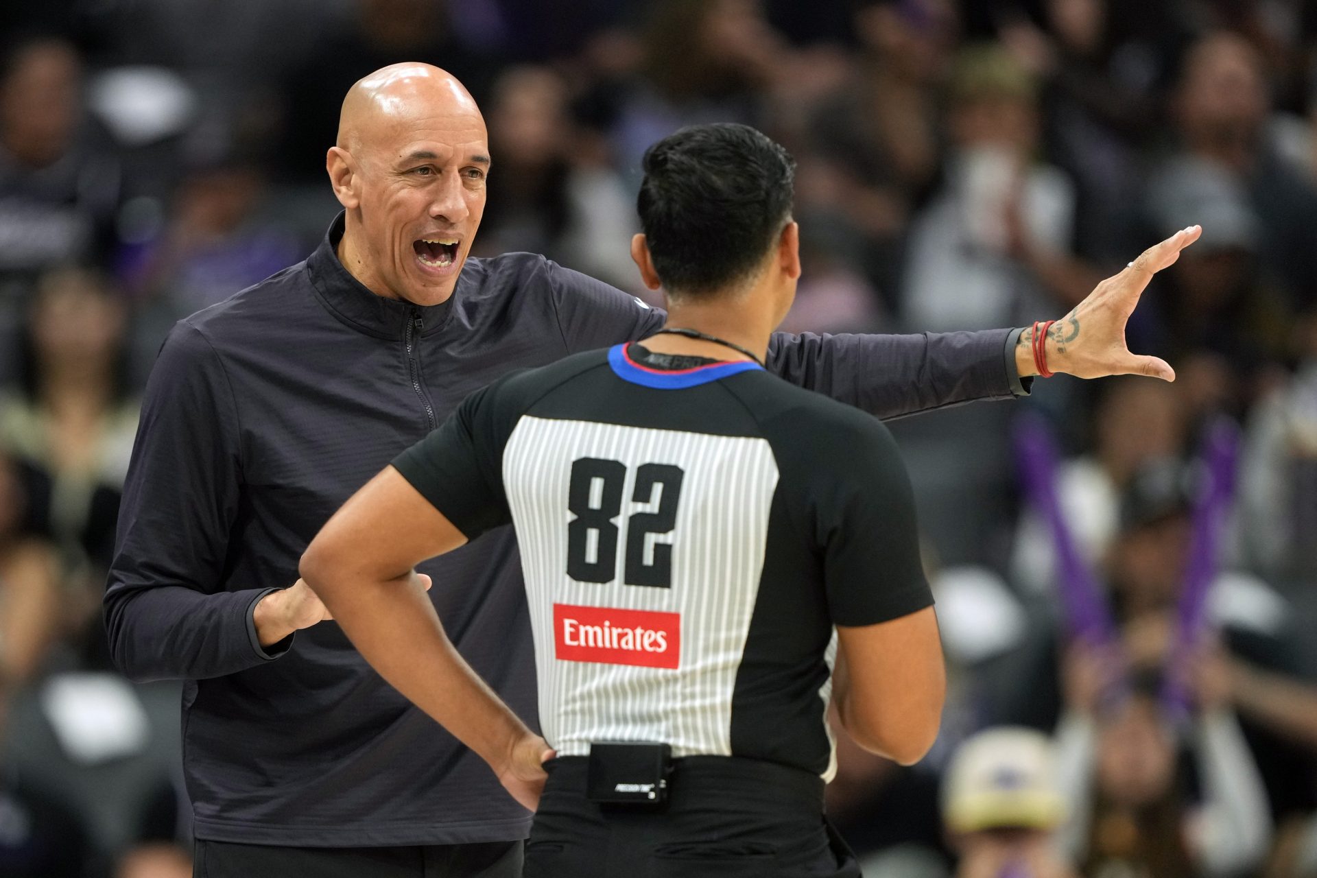 Sacramento Kings head coach Doug Christie (left) talks with referee Suyash Mehta (82) during the third quarter against the New Orleans Pelicans at Golden 1 Center. - Source: Imagn