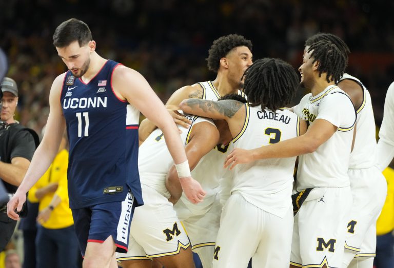 Michigan Wolverines players celebrate after defeating the Connecticut Huskies in the national championship of the Final Four of the men's 2026 NCAA Tournament at Lucas Oil Stadium. Source: Robert Deutsch-Imagn Images