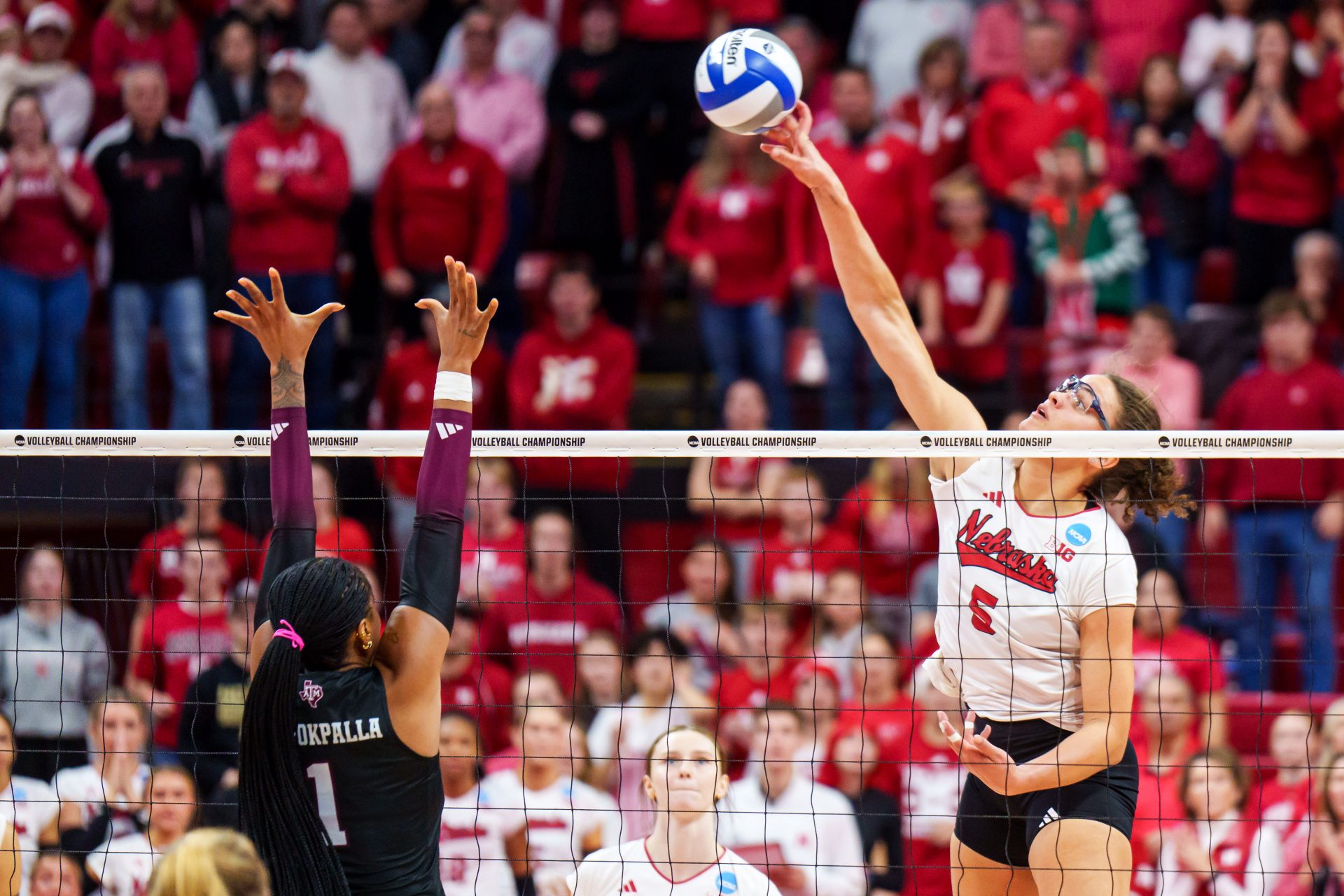 Nebraska Cornhuskers middle blocker Rebekah Allick (5) attacks against Texas A&M Aggies middle blocker Ifenna Cos-Okpalla (1) during the fourth set at Bob Devaney Sports Center. Source: Imagn