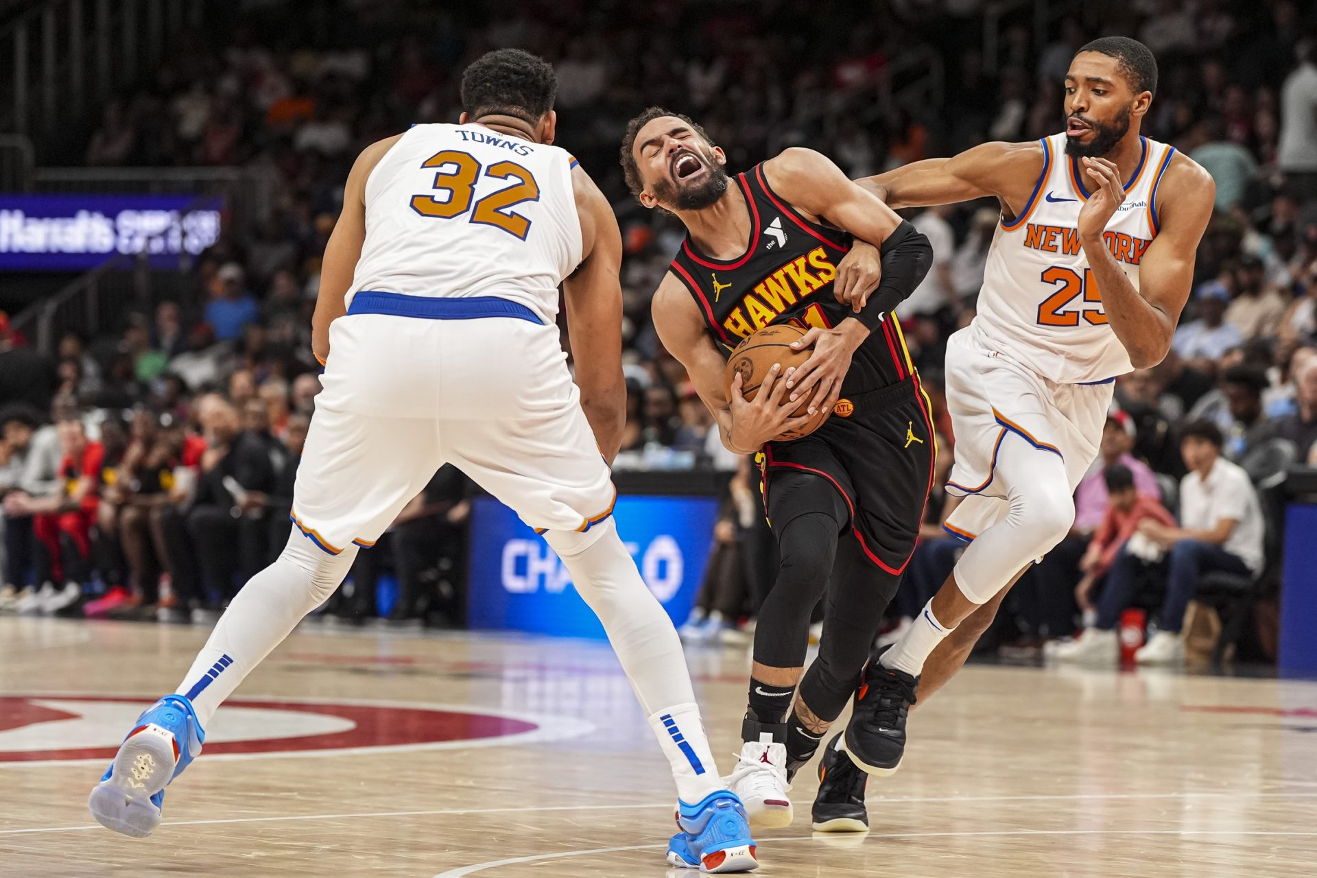 Atlanta Hawks guard Trae Young (11) tries to get through New York Knicks center Karl-Anthony Towns (32) and forward Mikal Bridges (25) during the second half at State Farm Arena. - Source: Imagn
