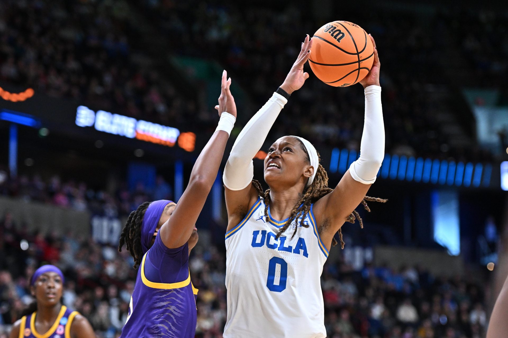 UCLA Bruins forward Janiah Barker (0) shoots against LSU Lady Tigers forward Sa'Myah Smith (5) during the first half of a Elite 8 NCAA Tournament basketball game at Spokane Arena.
