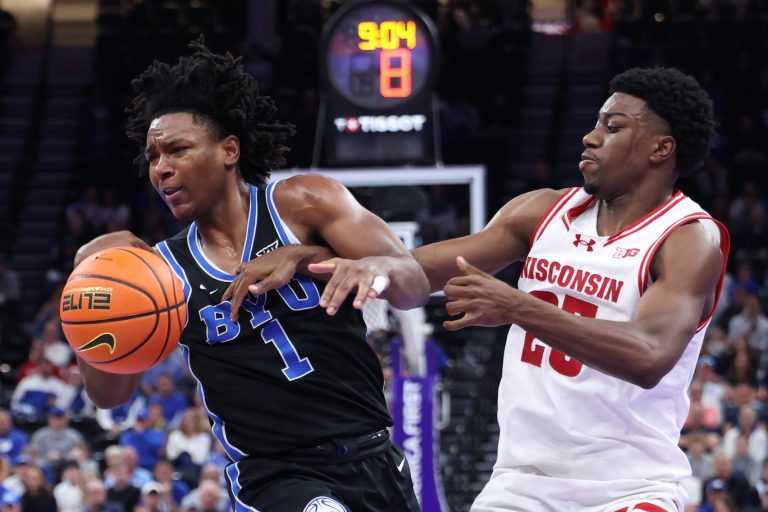BYU Cougars guard Robert Wright III (1) and Wisconsin Badgers guard John Blackwell (25) get tied up during the second half at Delta Center - Source: Imagn