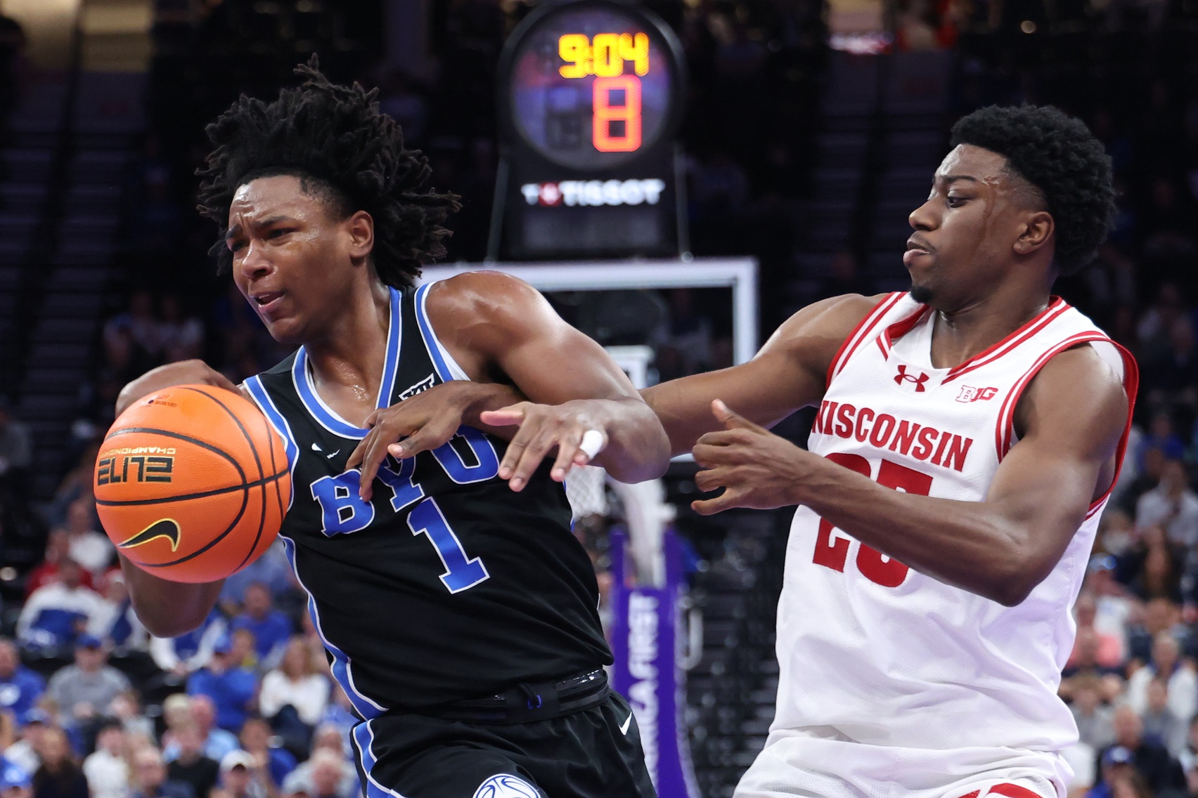 BYU Cougars guard Robert Wright III (1) and Wisconsin Badgers guard John Blackwell (25) get tied up during the second half at Delta Center - Source: Imagn