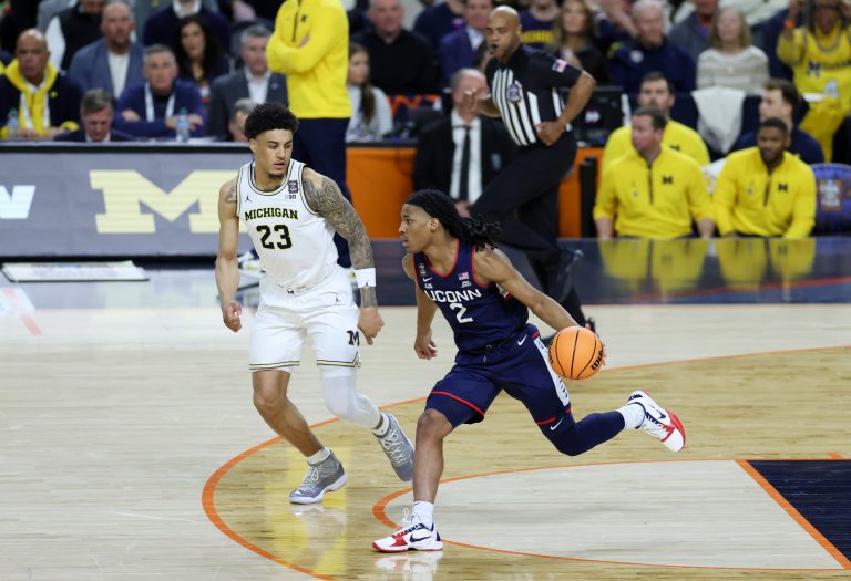 UConn Huskies guard Silas Demary Jr. (2) dribbles the ball against Michigan Wolverines forward Yaxel Lendeborg (23) in the second half during the national championship of the Final Four of the men's 2026 NCAA Tournament at Lucas Oil Stadium. Source: Trevor Ruszkowski-Imagn Images