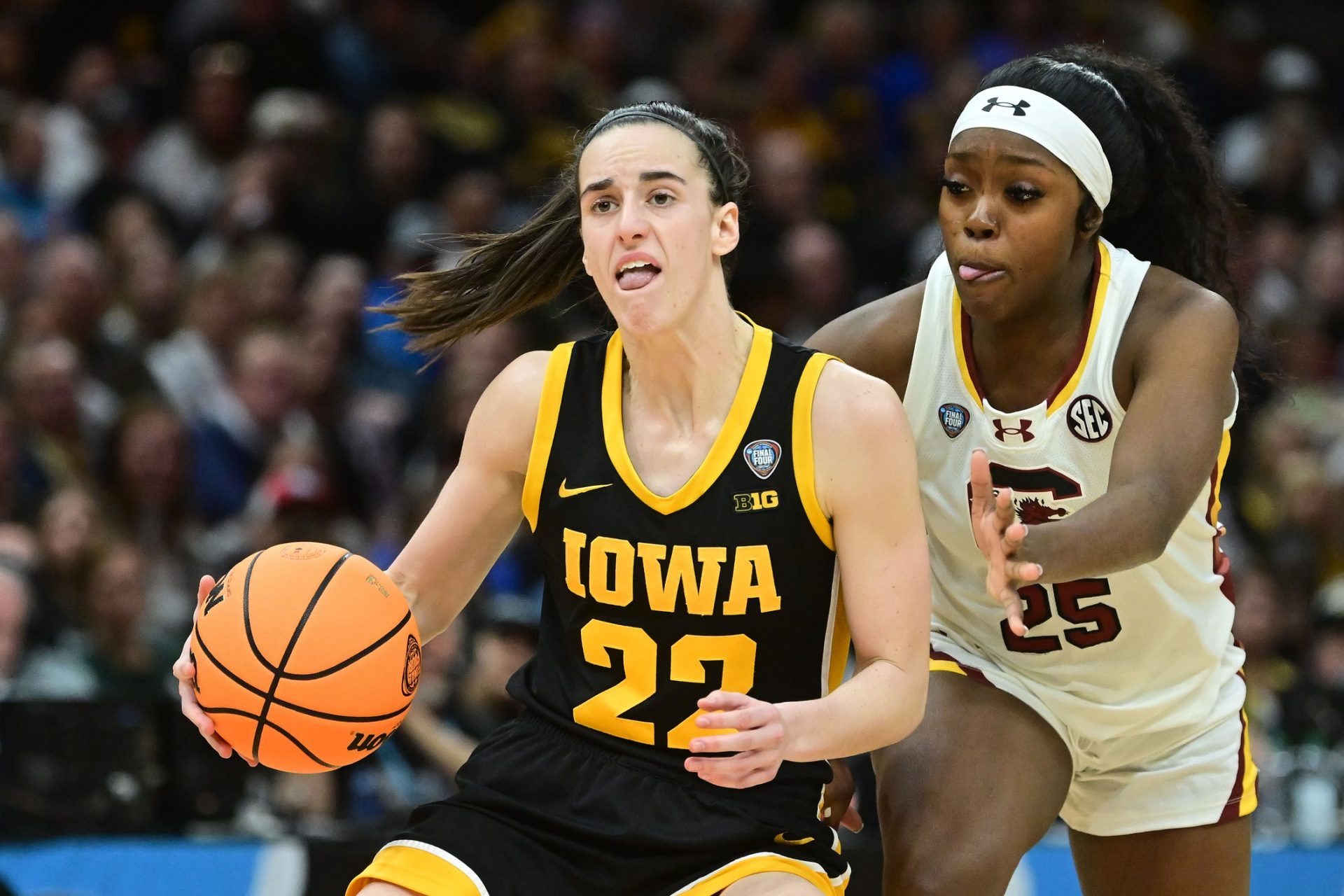 Iowa Hawkeyes guard Caitlin Clark (22) dribbles the ball past South Carolina Gamecocks guard Raven Johnson (25) - Source: IMAGN