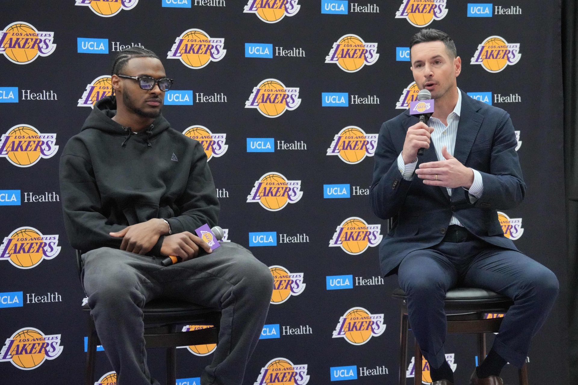 Los Angeles Lakers coach JJ Redick (right) and second-round draft pick Bronny James at a press conference at the UCLA Health Training Center. - Source: Imagn