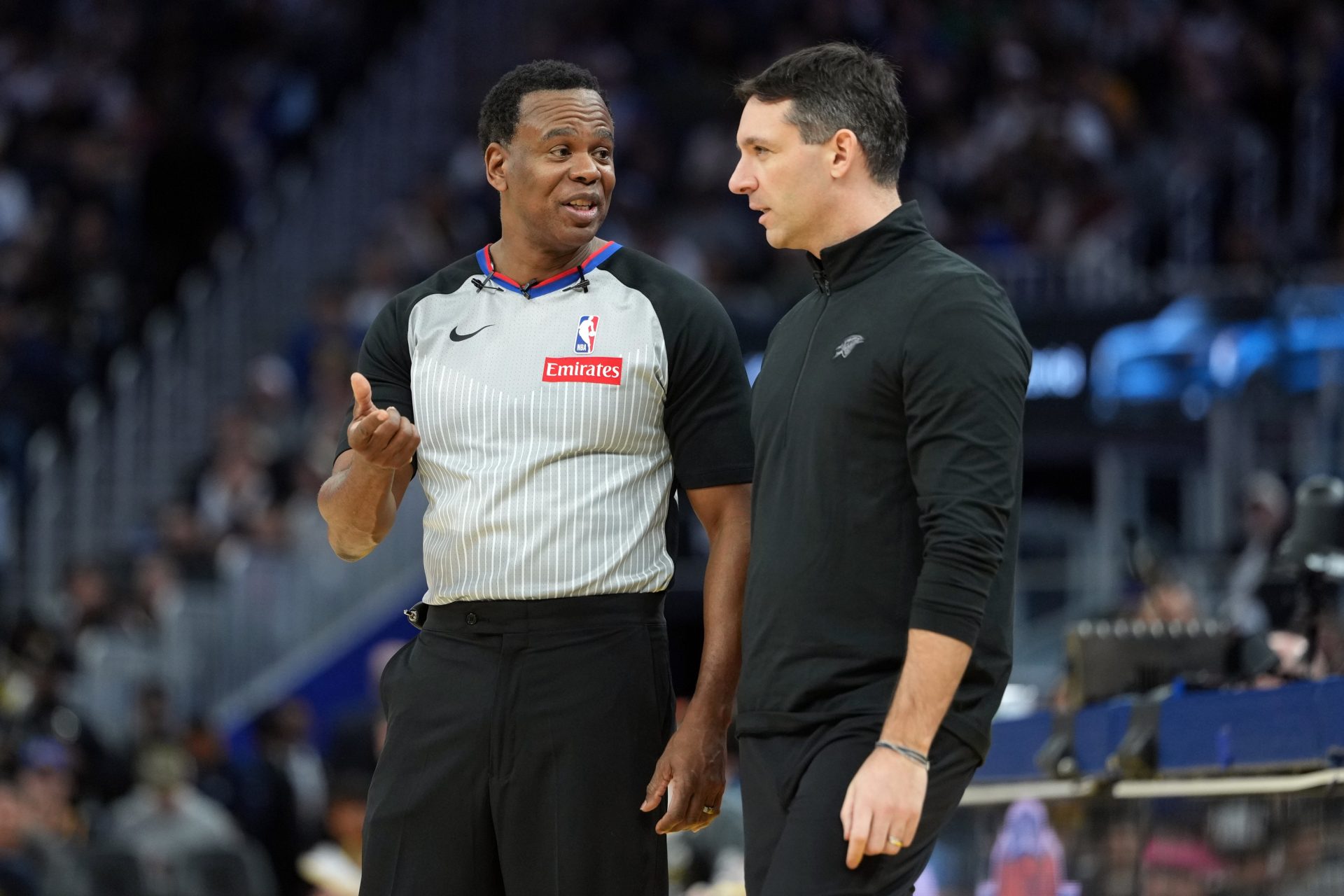 Referee Sean Wright (left) talks with Oklahoma City Thunder head coach Mark Daigneault (right) during the third quarter against the Golden State Warriors at Chase Center. - Source: Imagn