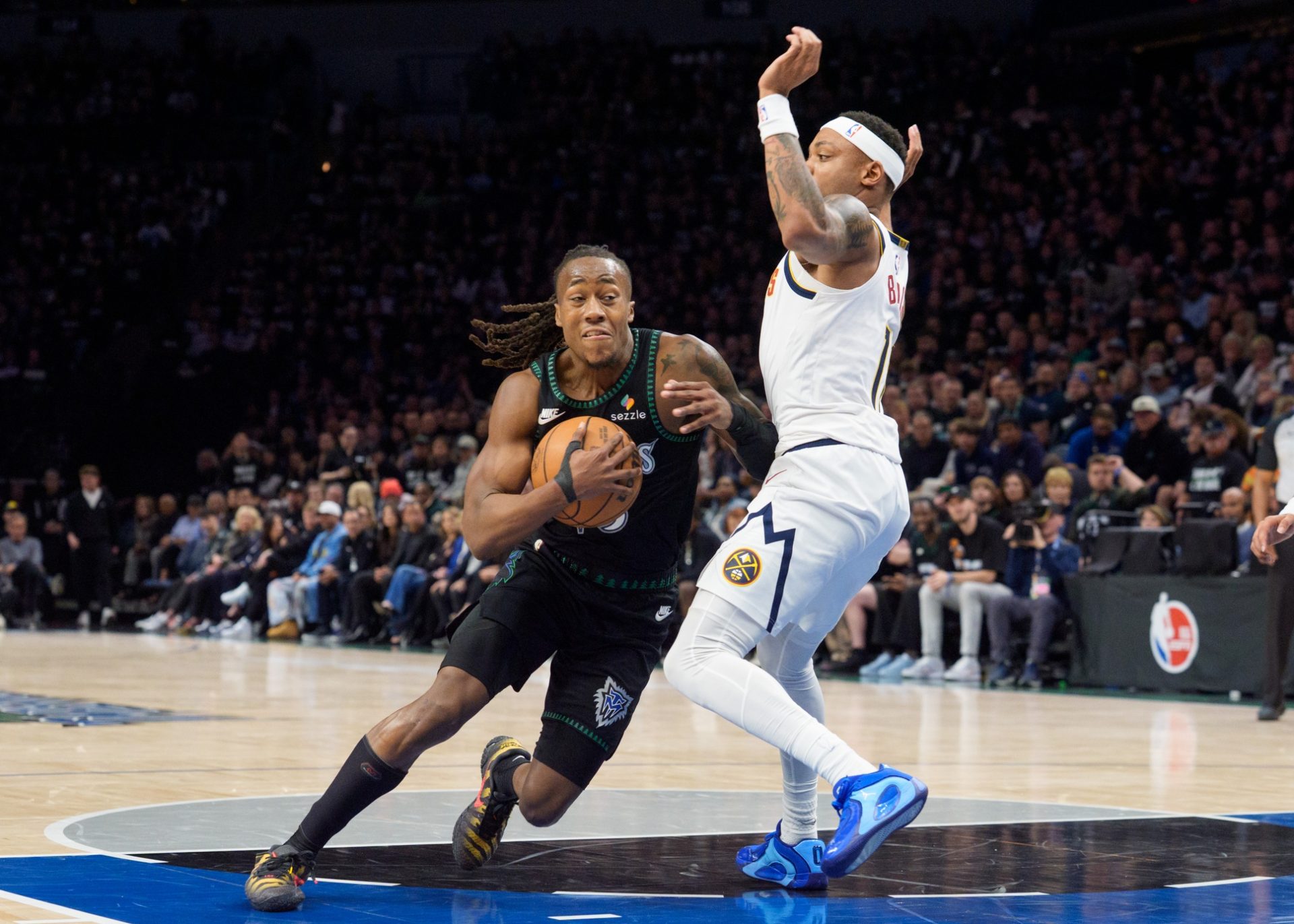 Minnesota Timberwolves guard Ayo Dosunmu (13) drives to the basket against Denver Nuggets guard Bruce Brown (11) in the second quarter at Target Center.