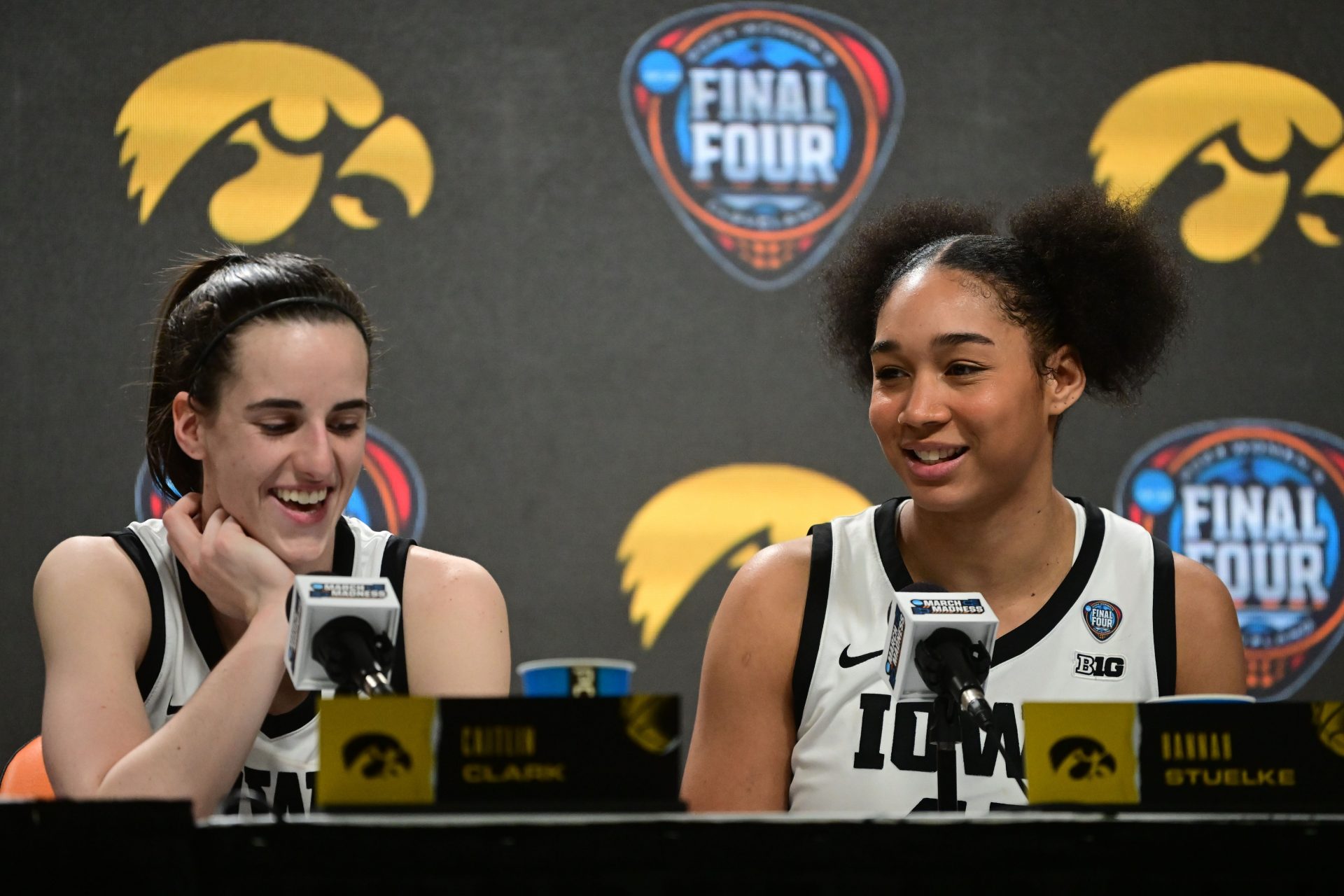 Iowa Hawkeyes guard Caitlin Clark (left) and forward Hannah Stuelke (right) speak to the media after defeating the Connecticut Huskies in the semifinals of the Final Four of the womens 2024 NCAA Tournament at Rocket Mortgage FieldHouse. - Source: USA Today Sports