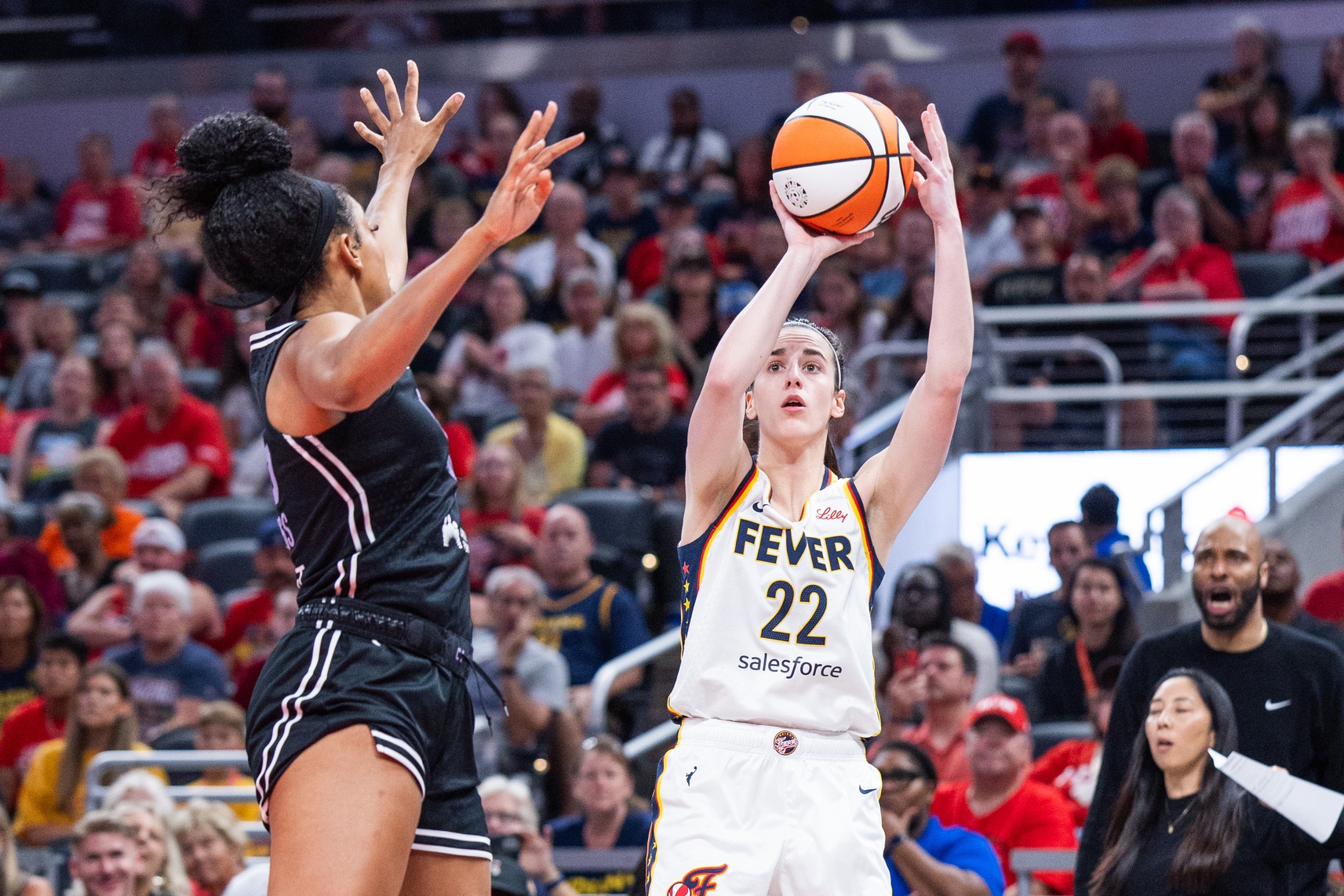Indiana Fever guard Caitlin Clark (22) shoots the ball while Golden State Valkyries forward Monique Billings (25) defends in the first half at Gainbridge Fieldhouse. - Source: Imagn