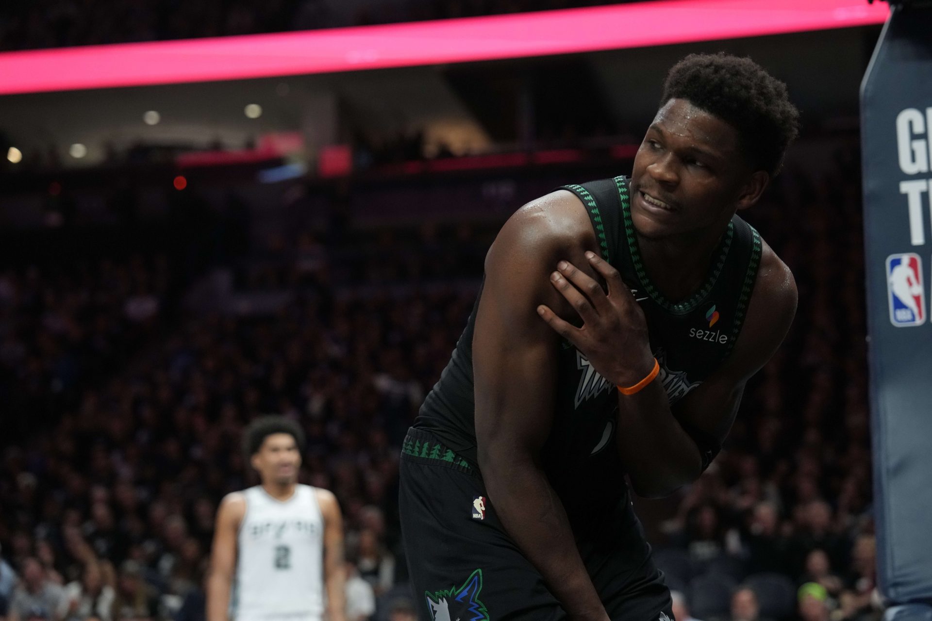 Minnesota Timberwolves guard Anthony Edwards (5) holds his shoulder after making contact with another player against the San Antonio Spurs in the second half during game six of the second round of the 2026 NBA Playoffs at Target Center - Source: Imagn Images