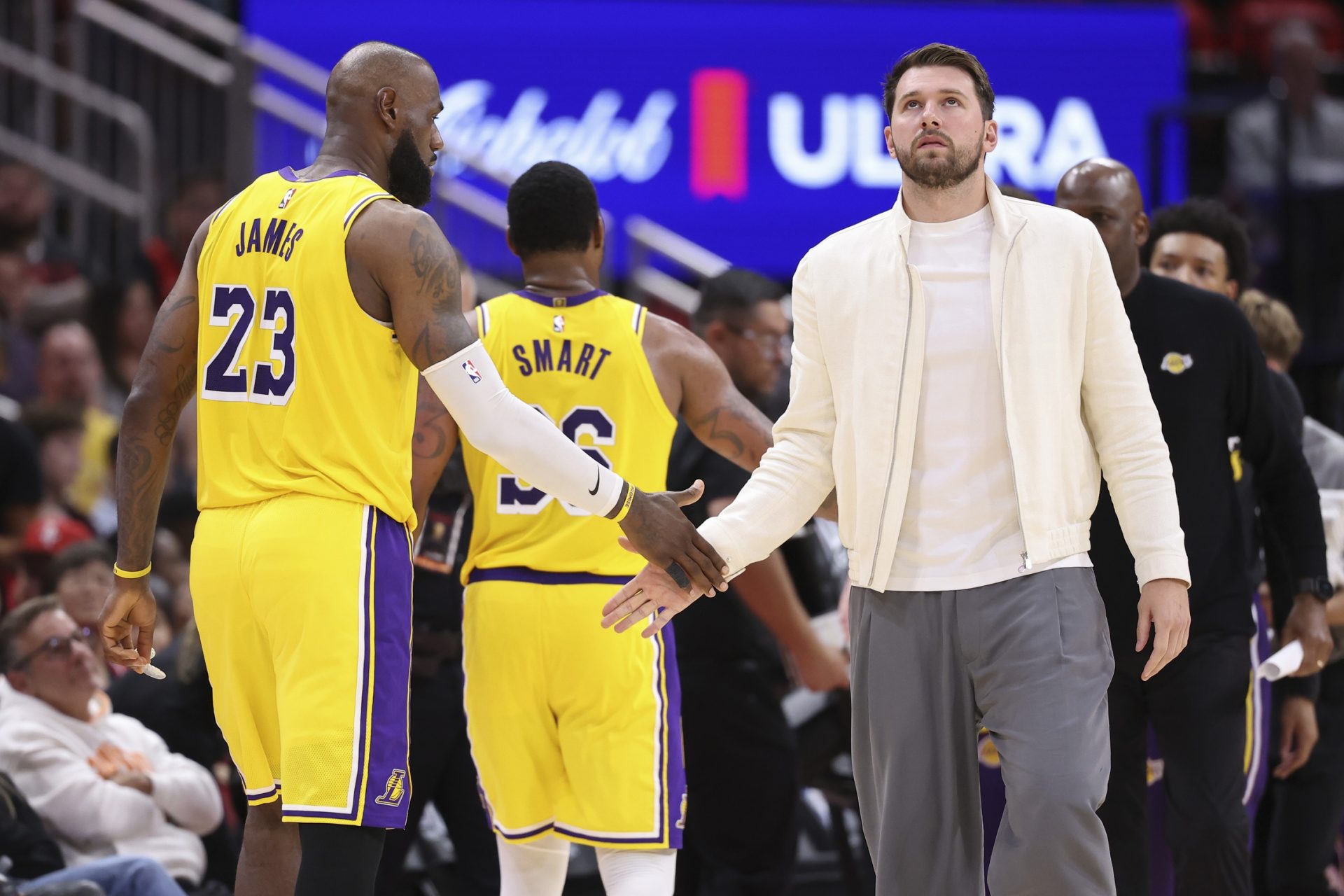Los Angeles Lakers forward/guard Luka Doncic shakes hands with forward LeBron James (23) during the third quarter against the Houston Rockets during game three of the first round of the 2026 NBA Playoffs at Toyota Center.