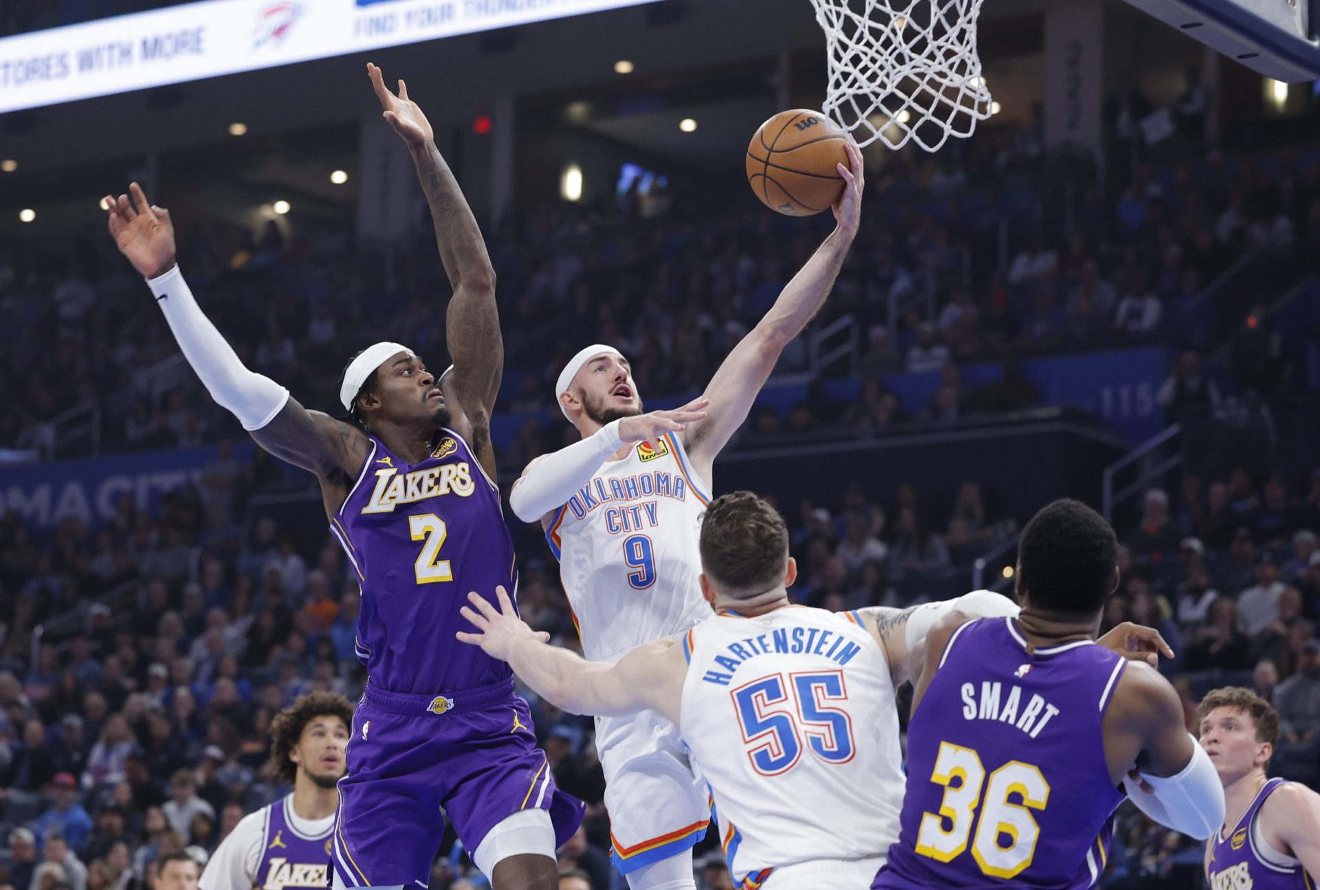 Oklahoma City Thunder guard Alex Caruso (9) goes up for a basket beside Los Angeles Lakers forward Jarred Vanderbilt (2) during the second quarter at Paycom Center.
