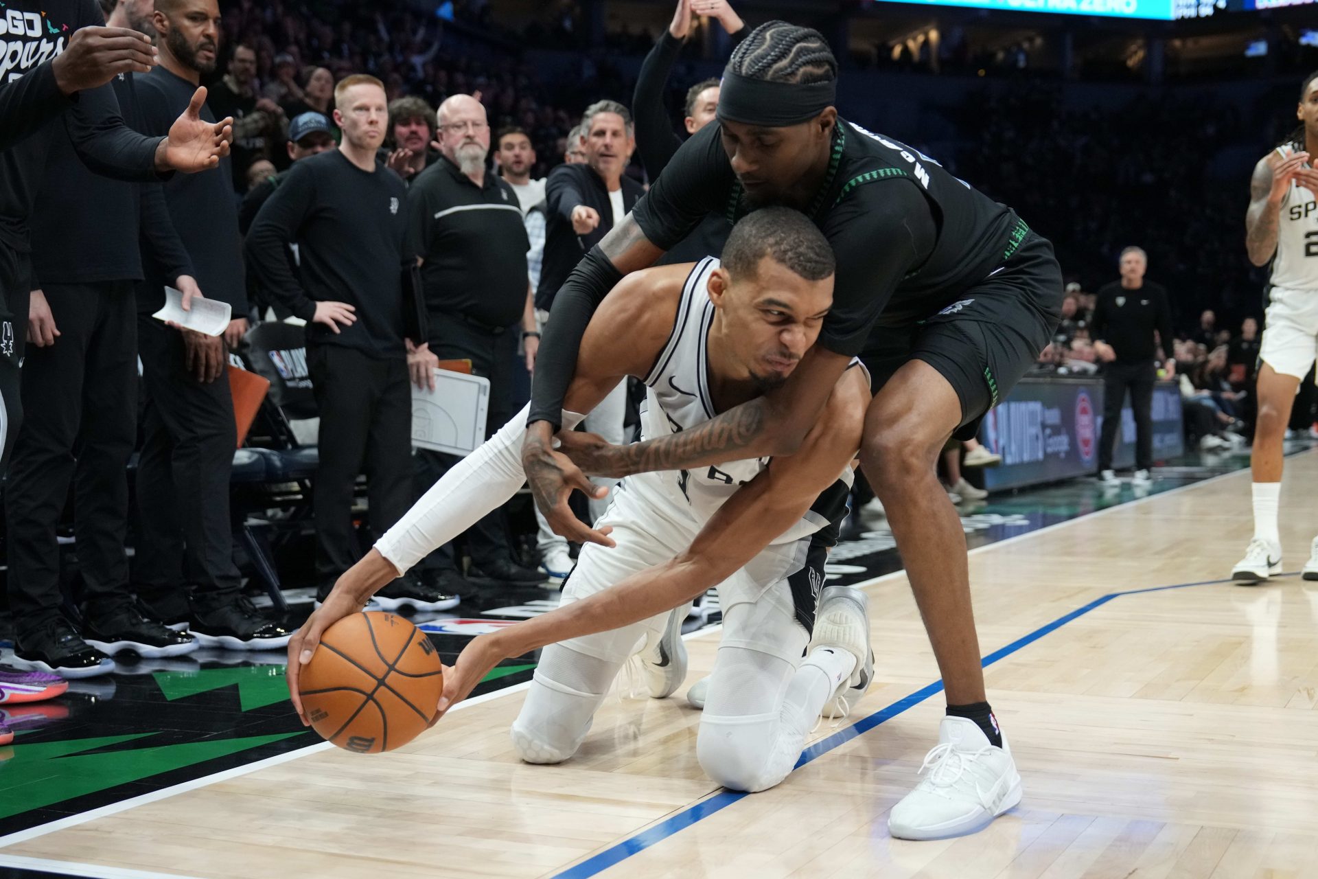 San Antonio Spurs forward Victor Wembanyama (1) tries to keep the ball away from Minnesota Timberwolves forward Jaden McDaniels (3) in the second half during game three of the second round of the 2026 NBA Playoffs at Target Center.