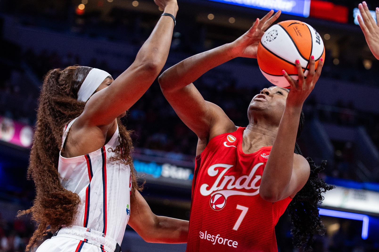 Indiana Fever center-forward Aliyah Boston (7) shoots the ball while Washington Mystics forward Kiki Iriafen (44) defends in the second half at Gainbridge Fieldhouse.