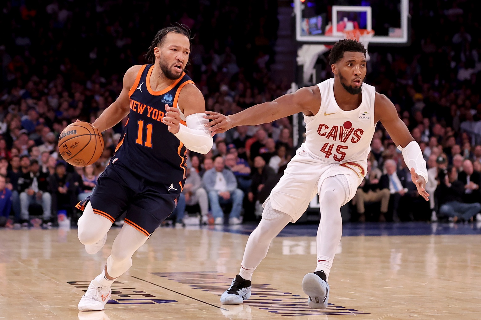 New York Knicks guard Jalen Brunson (11) controls the ball against Cleveland Cavaliers guard Donovan Mitchell (45) during the fourth quarter at Madison Square Garden.