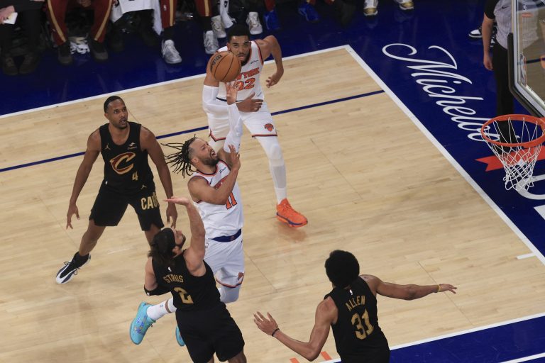 New York Knicks guard Jalen Brunson (11) shoots against Cleveland Cavaliers guard Max Strus (2) and center Jarrett Allen (31) during the second quarter of game one of the eastern conference finals for the 2026 NBA playoffs at Madison Square Garden.